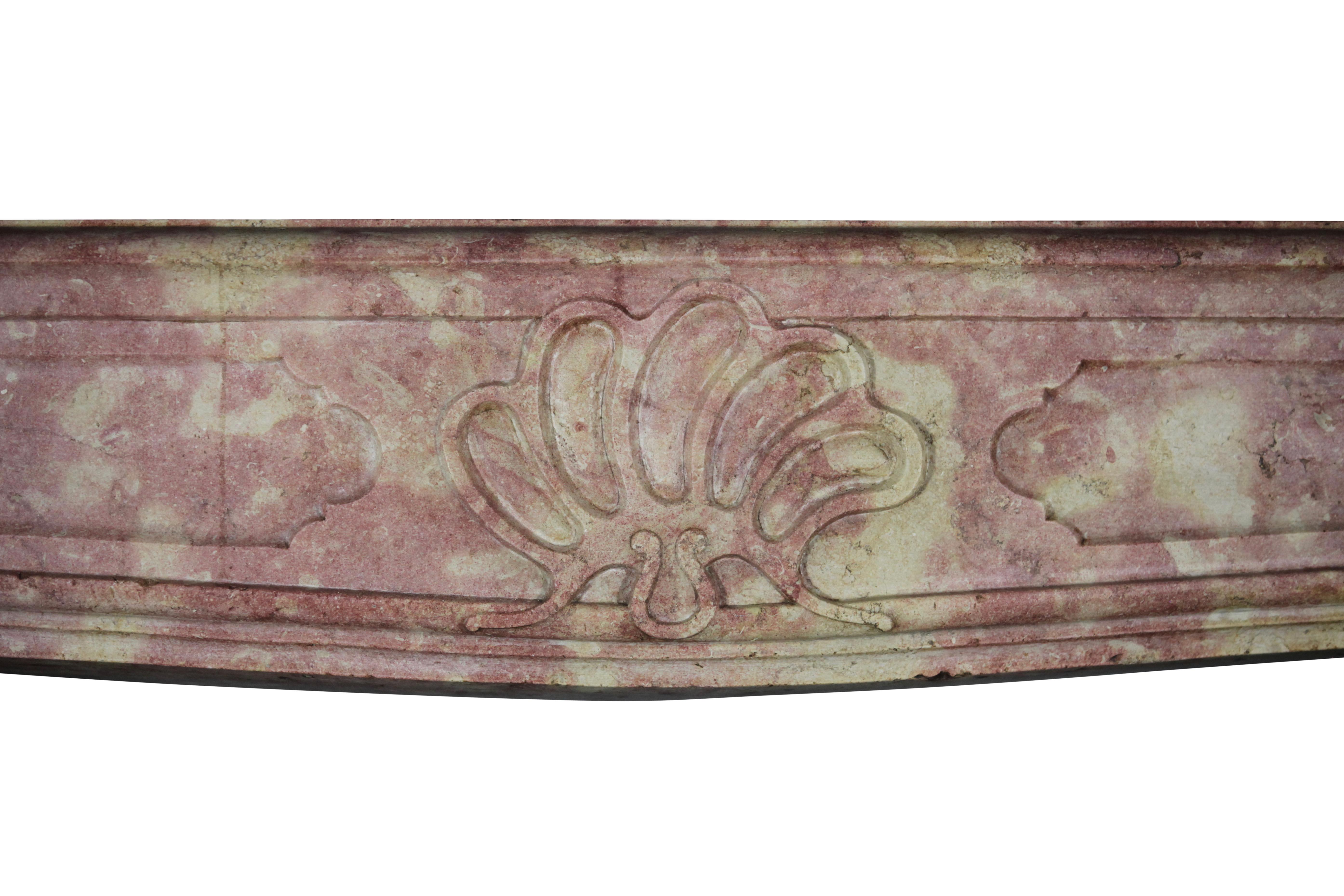 This original fine European antique fireplace surround is coming from the French Burgundy region. It is a regency period mantle piece in Burgundy hard stone. It also has retour to built a double upper mantle. The mantle has a French naive country
