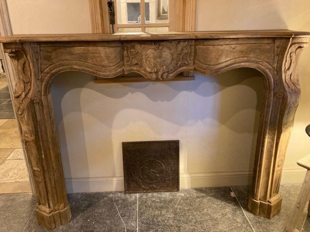 Oak wooden fireplace mantel from Sologne in France, and dating from the 18th Century 
Inside dimensions : 134cm wide & 106cm high