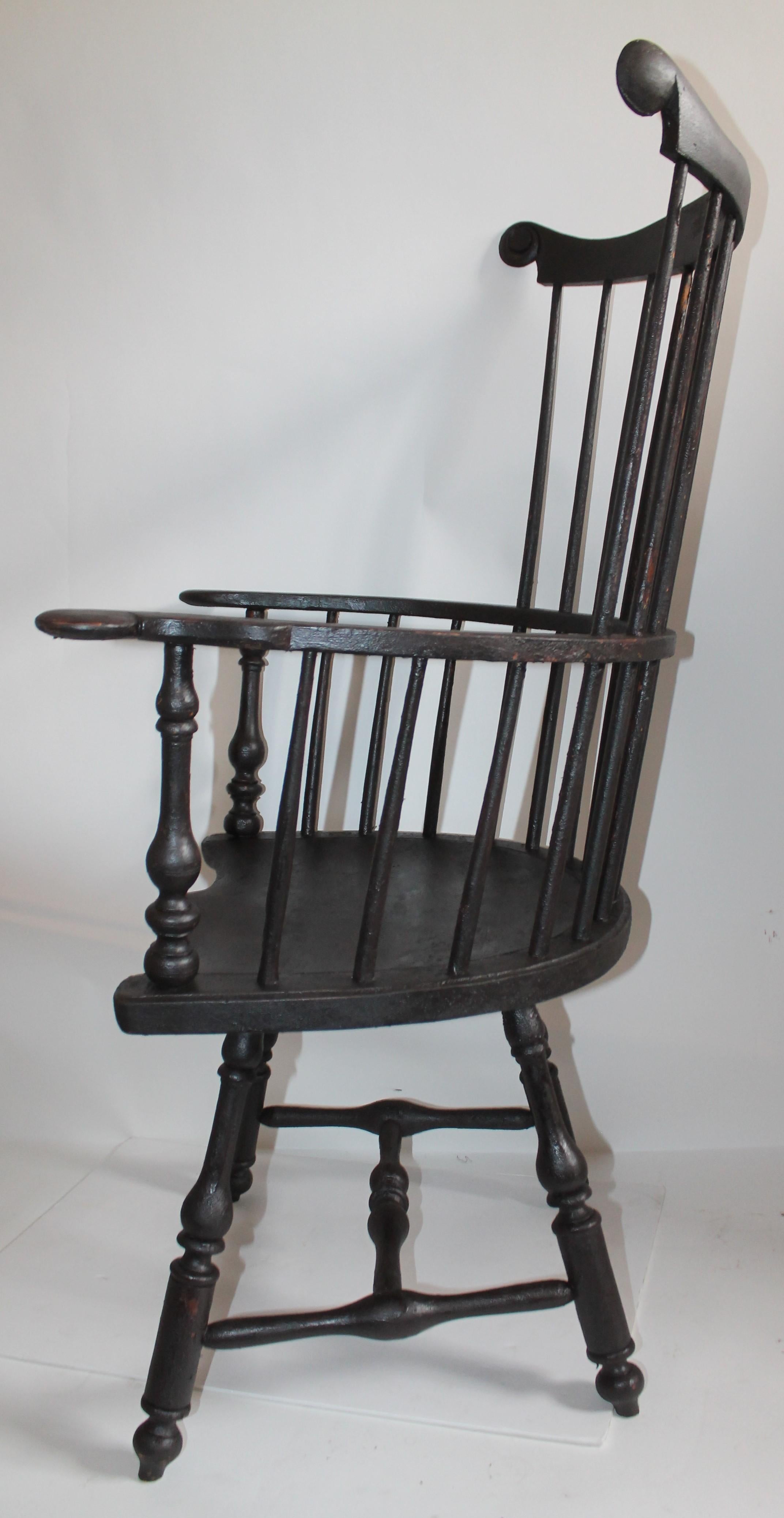 Reproduction of an 18th century oversized butterfly Windsor chair. Amazing black over paint surface and patina to this chair.