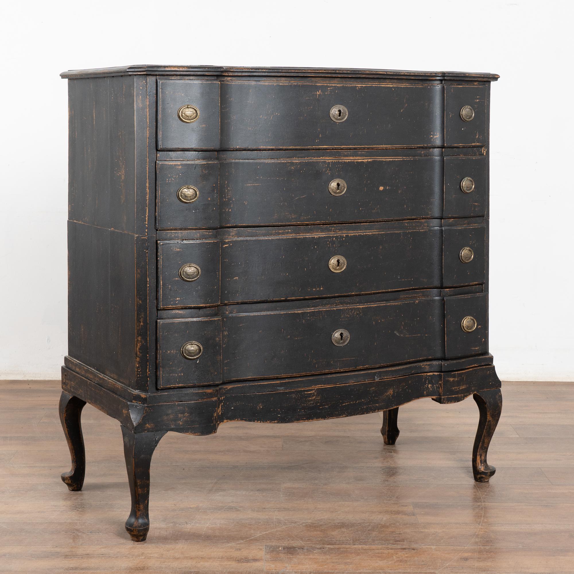 The black painted finish is striking in this attractive large oak chest of four drawers resting on scalloped skirt and curved cabriolet legs.
While the paint is newer and professionally applied, it compliments the age, rococo style and serpentine