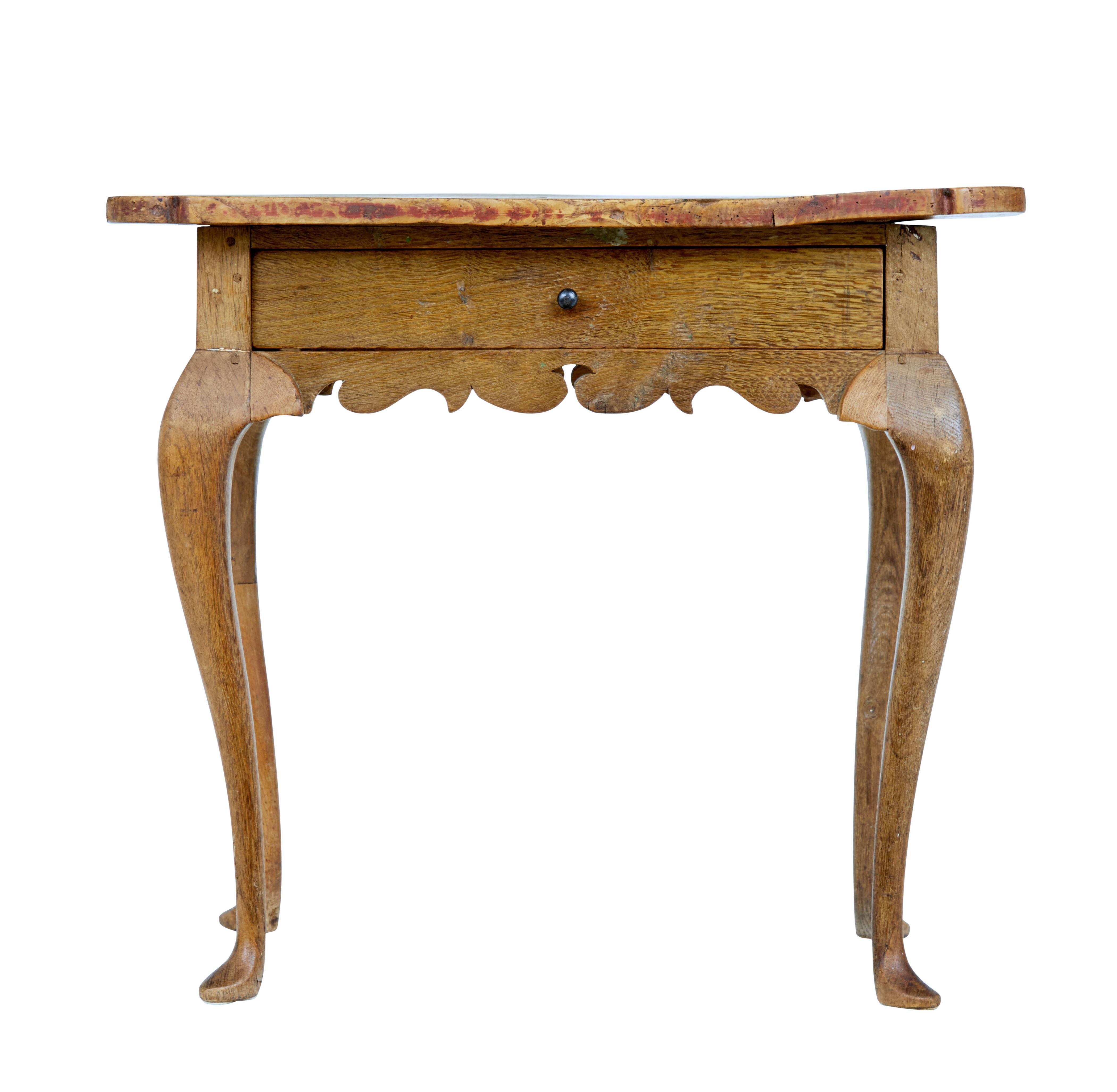18th century Rococo period elm side table circa 1770.

Swedish table with over sailing burr top, single drawer below the top surface. Carved frieze which link to the cabriole legs and pad foot.

One 19th century restoration to 1 leg. Obvious