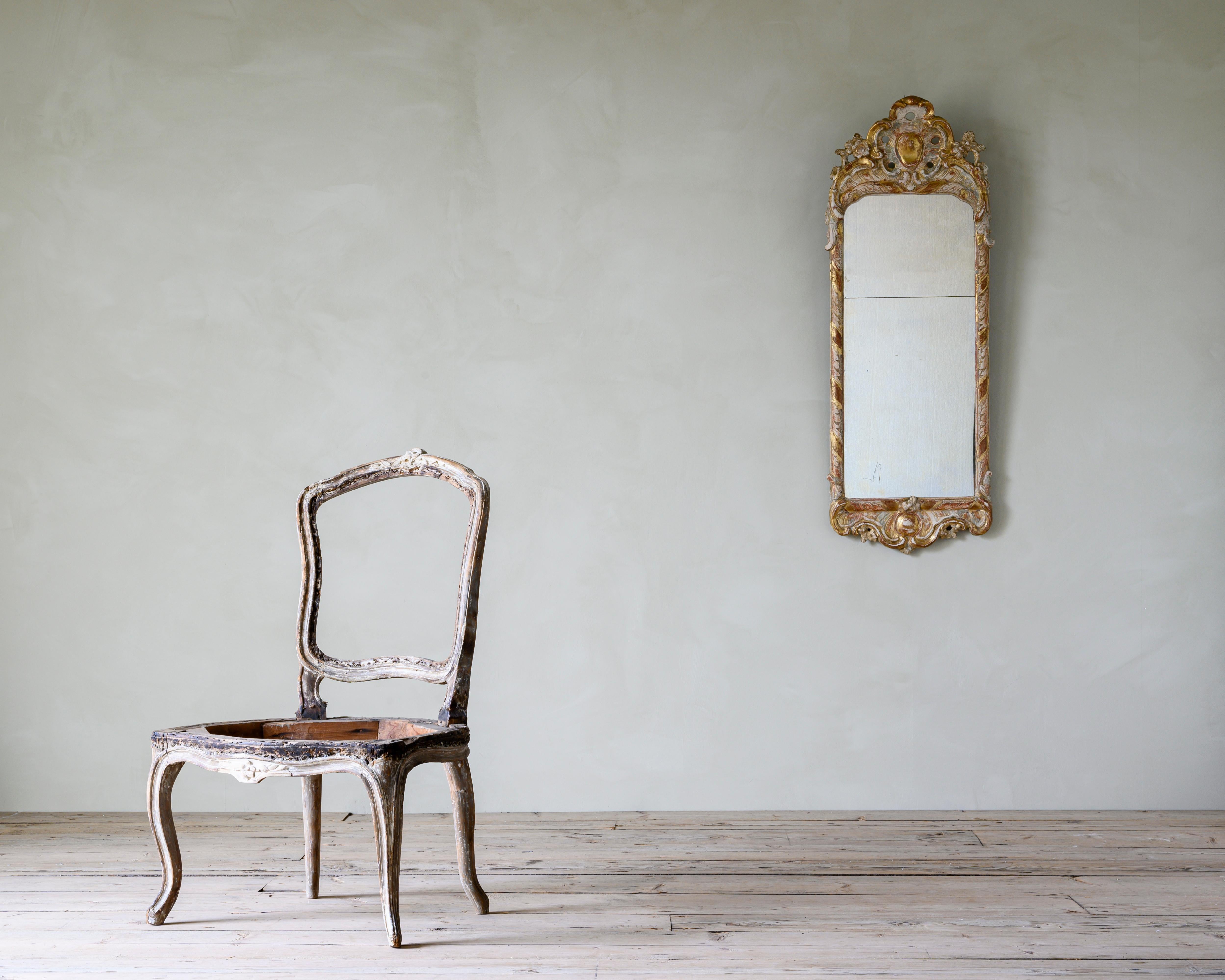 18th century Swedish giltwood mirror from the Rococo period, circa 1770. 

The condition is fair with traces of the original gilt, historical restorations. No issues with the structure.
