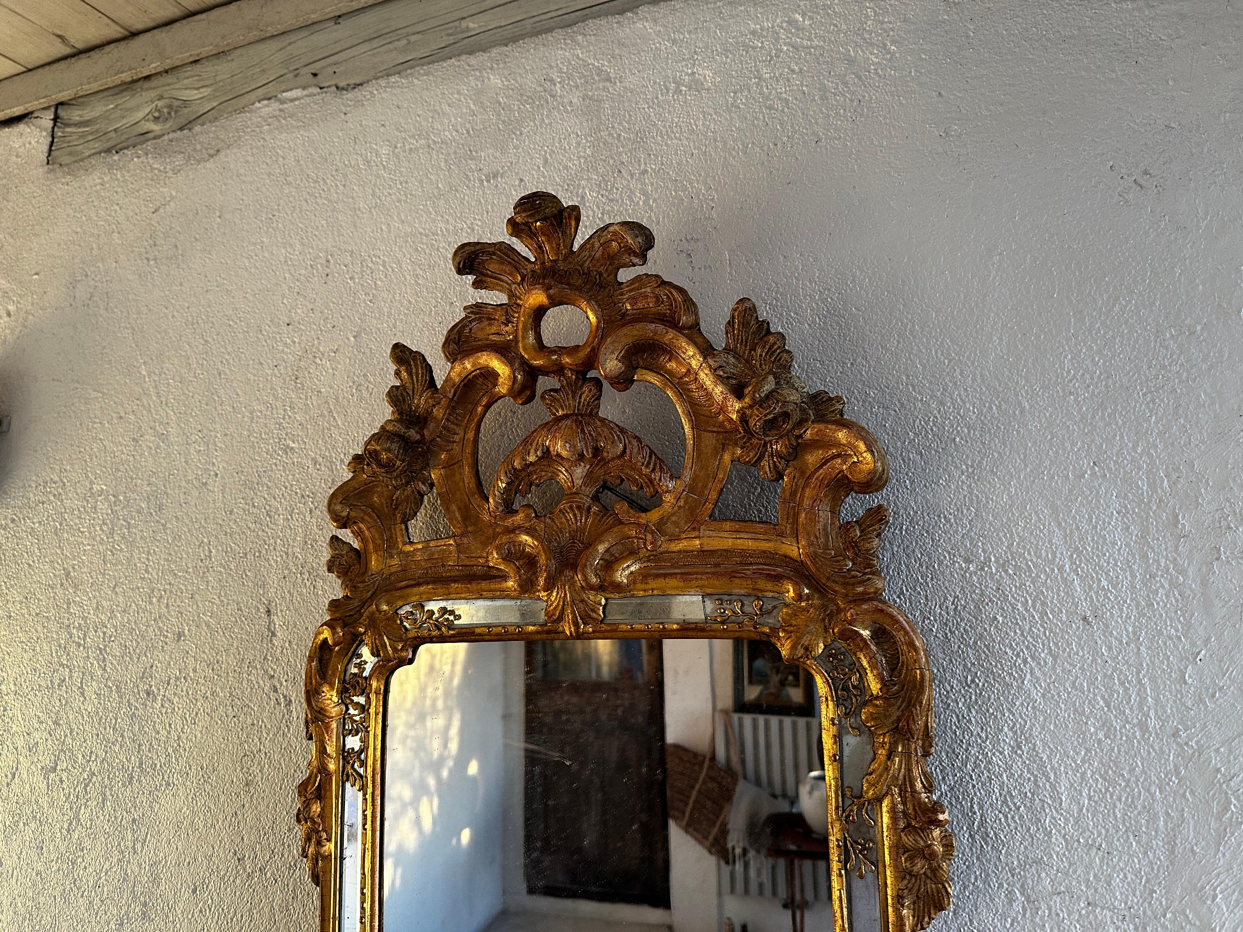 This Rococo mirror is attributed to Niclas Meunier, 1754-97. He worked in Stockholm as Royal maker of mirrors from 1769. Beautiful top with rocaille, volutes and acanthus. The bottom part is also decorated with a rocaille. Fine restoration with much