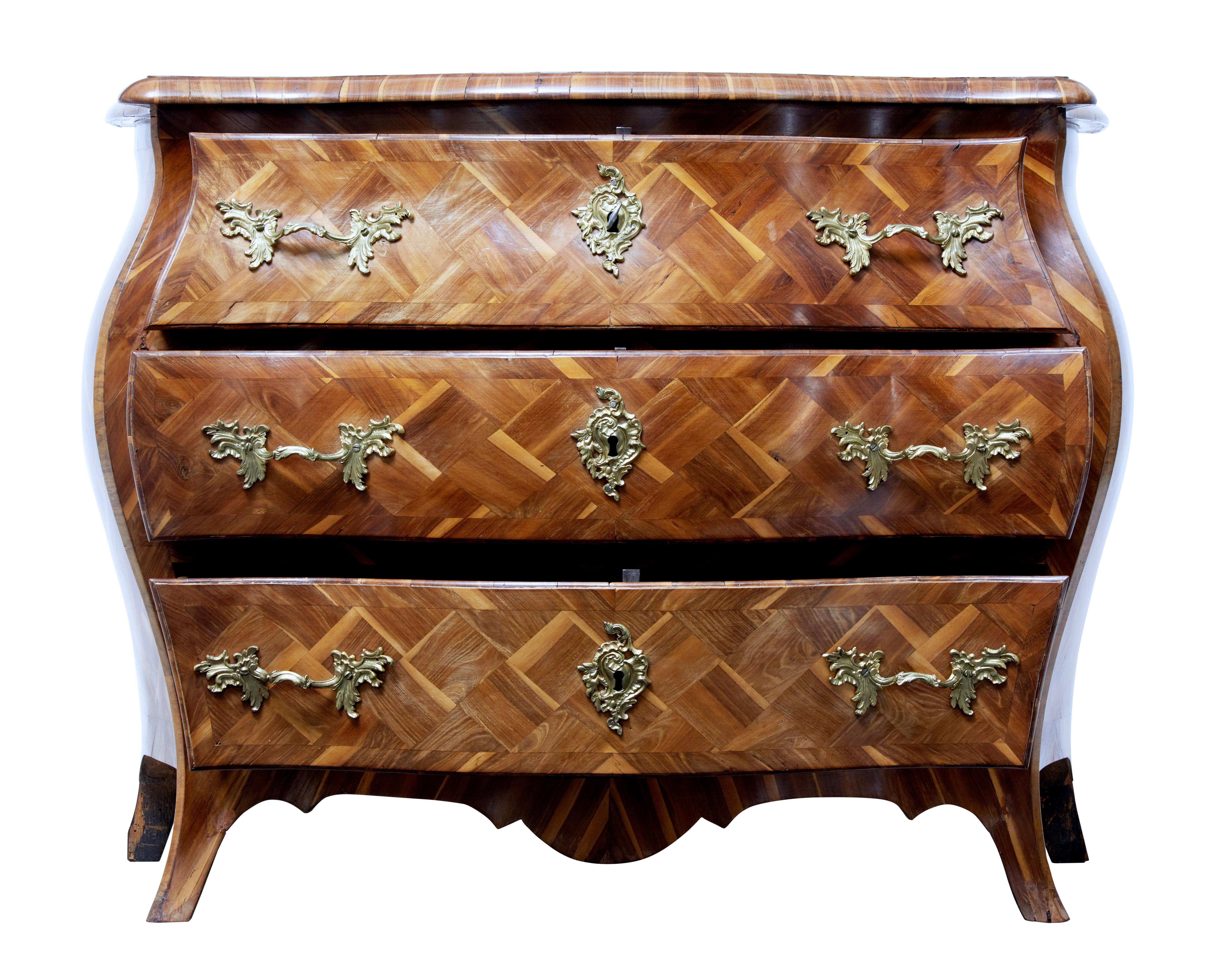 We are pleased to offer one of the finest commodes we have dealt in. Rococo period and made in plum wood, circa 1730.

Parquet has been finely arranged in angled squares and cross banded in the same plum wood.

Elegant bombe shape, three drawers