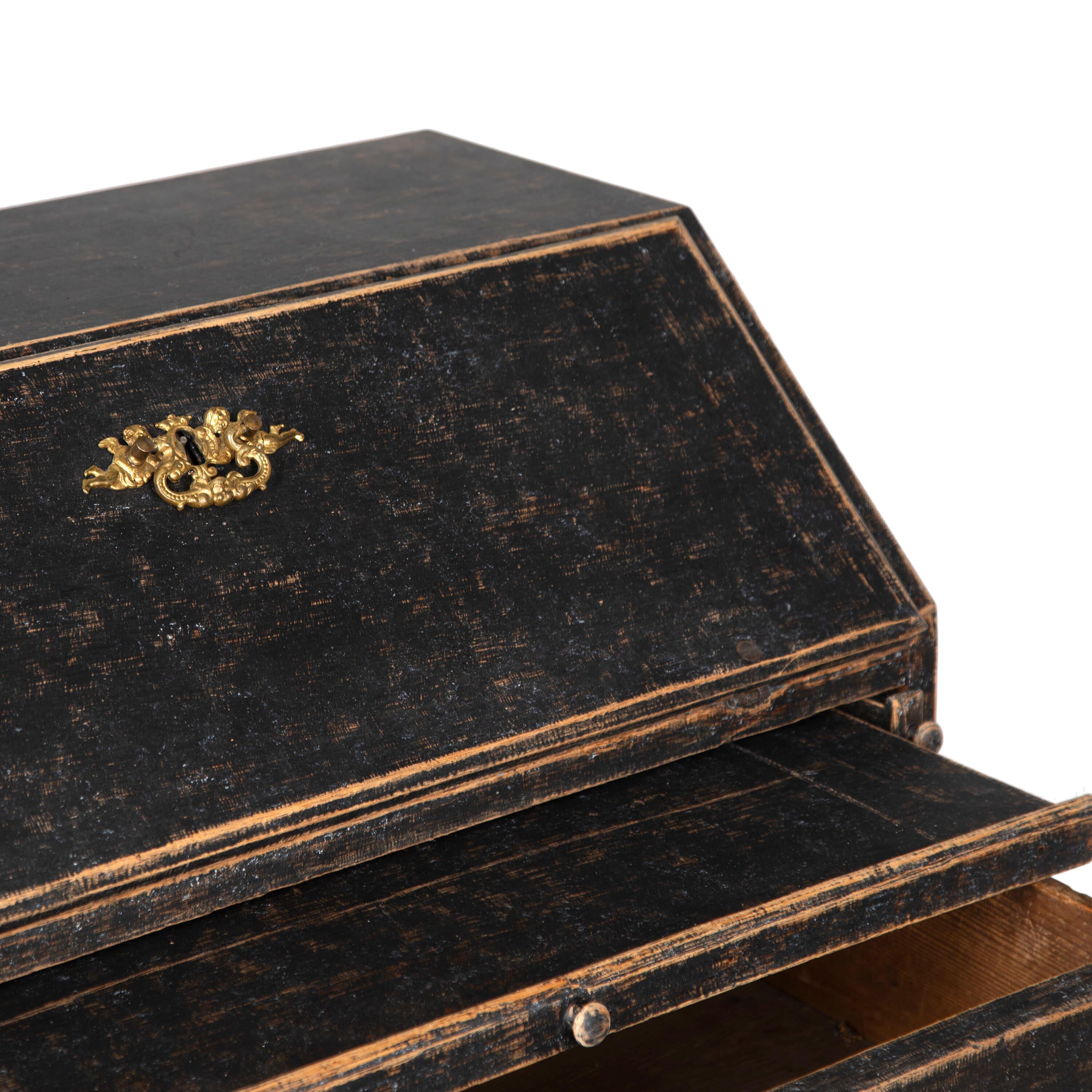 18th Century slant front Rococo desk.
With an attractive fall front desk opening to five compartments. Below are three further drawers.
Repainted black with a pale blue interior.