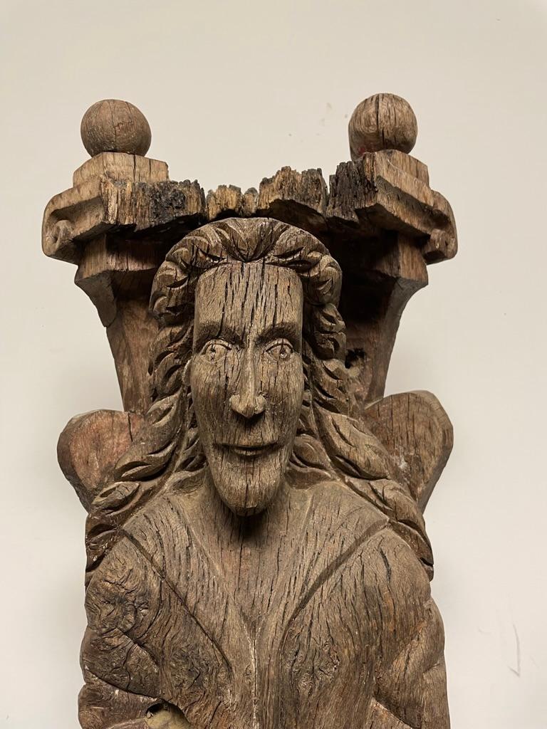 A very interesting Baroque period carved oak figure of a saint or prophet said to come from a demolished Russian Orthodox church. This compelling figure is set into a niche with round finials on top. The wonderful weathered surface and elongated