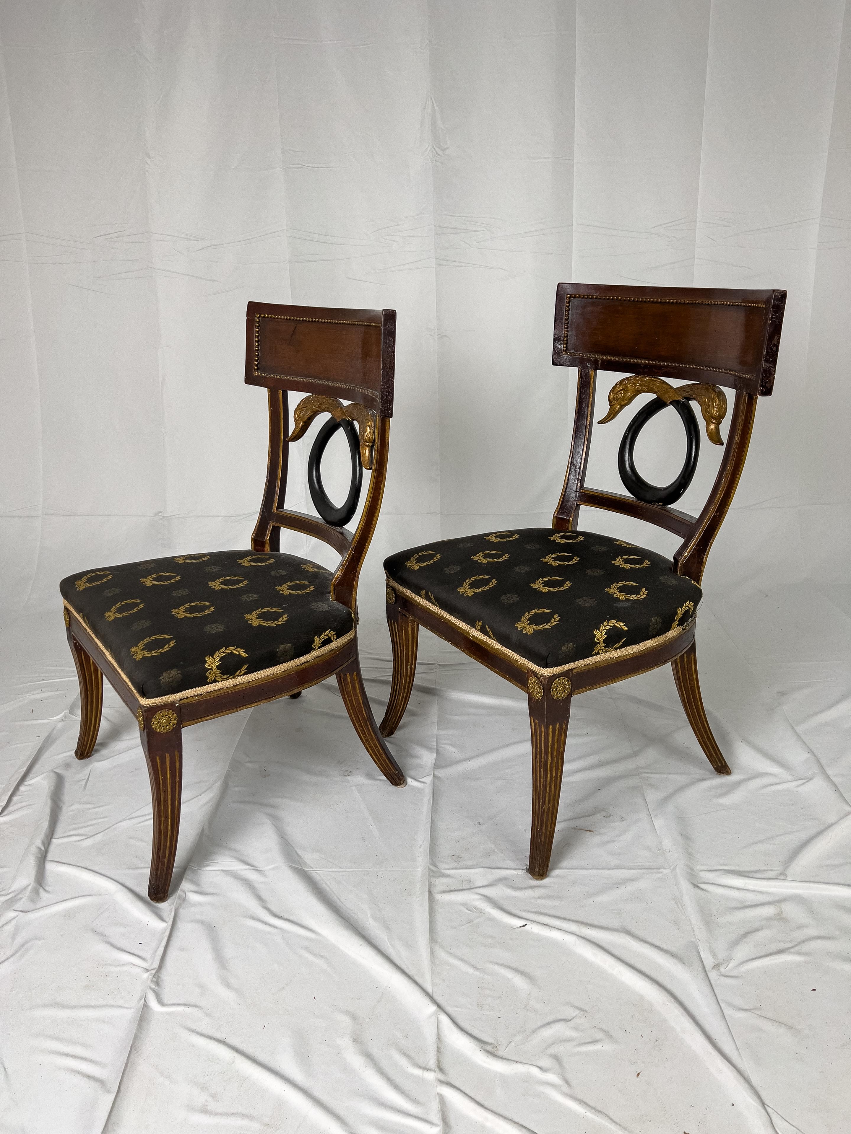 18th century Russian Empire style side chairs. The beaded block paneled crest rail is supported by ebonized and gilded double swan heads. The fluted front legs are surmounted by ormolu medallions.