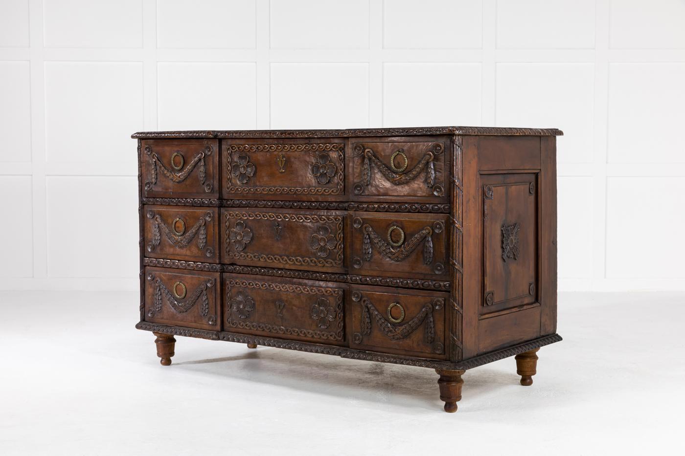 Wonderfully carved 18th century, rustic, cherry commode of well balanced proportions and has fantastic patina.