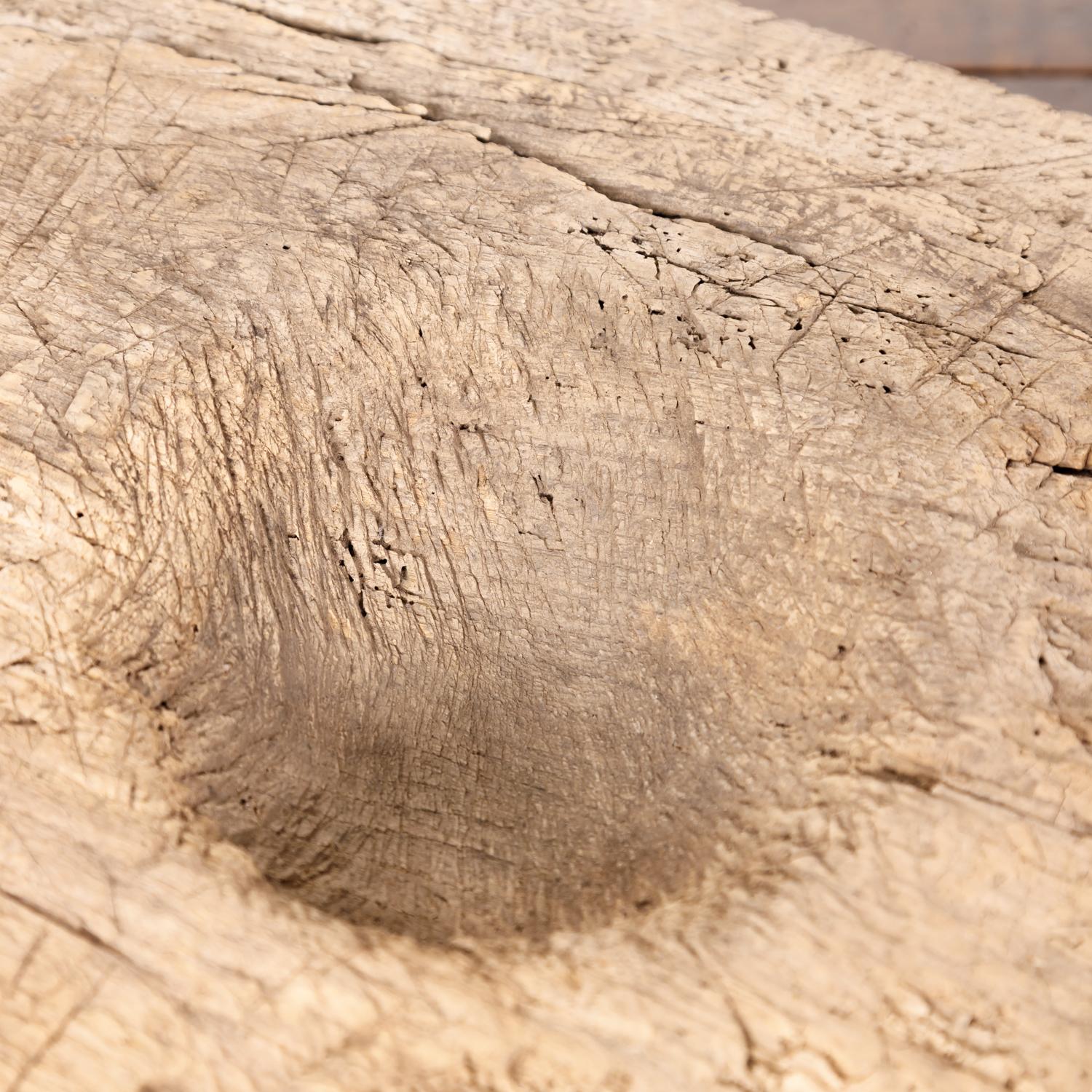 A large 18th century rustic French cutting board or chopping block with a handle and deep well for chopping herbs and garlic, circa 1780s. This thick and heavy board has a wonderfully timeworn patina from years of use showing knife marks and