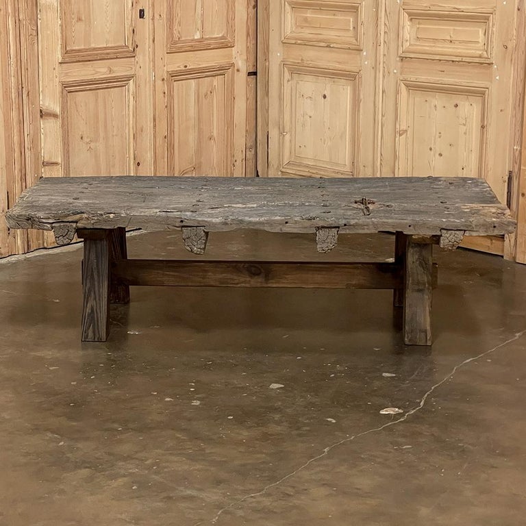 18th century rustic door repurposed as coffee table represents one of the most salient reasons why we like antiques so much! The creators of this solid plank and timber door two and a half centuries ago would never have imagined it soldiering on in