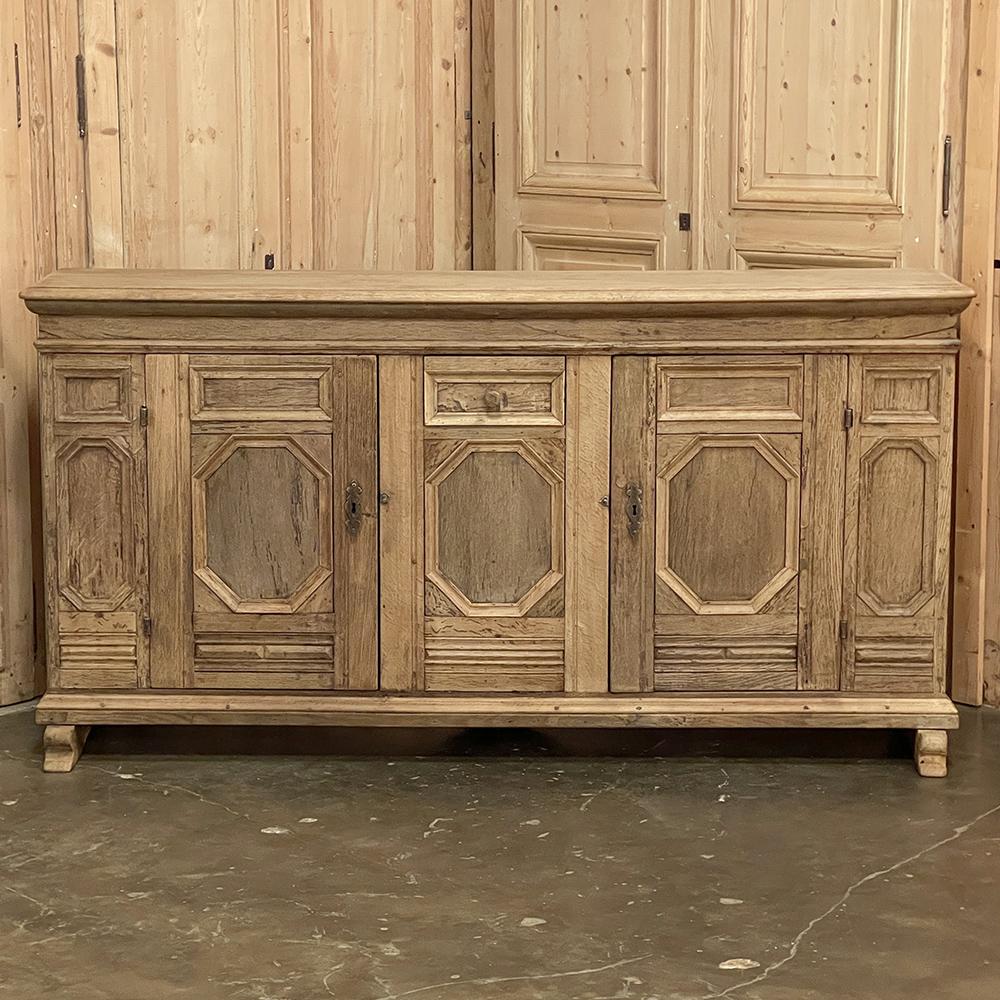 18th Century Rustic Dutch buffet in stripped oak is a study in country elegance, rendered in dense, old-growth indigenous oak to last for centuries! The no-nonsense design is enhanced by the intricate molded detailing that defines the panels,