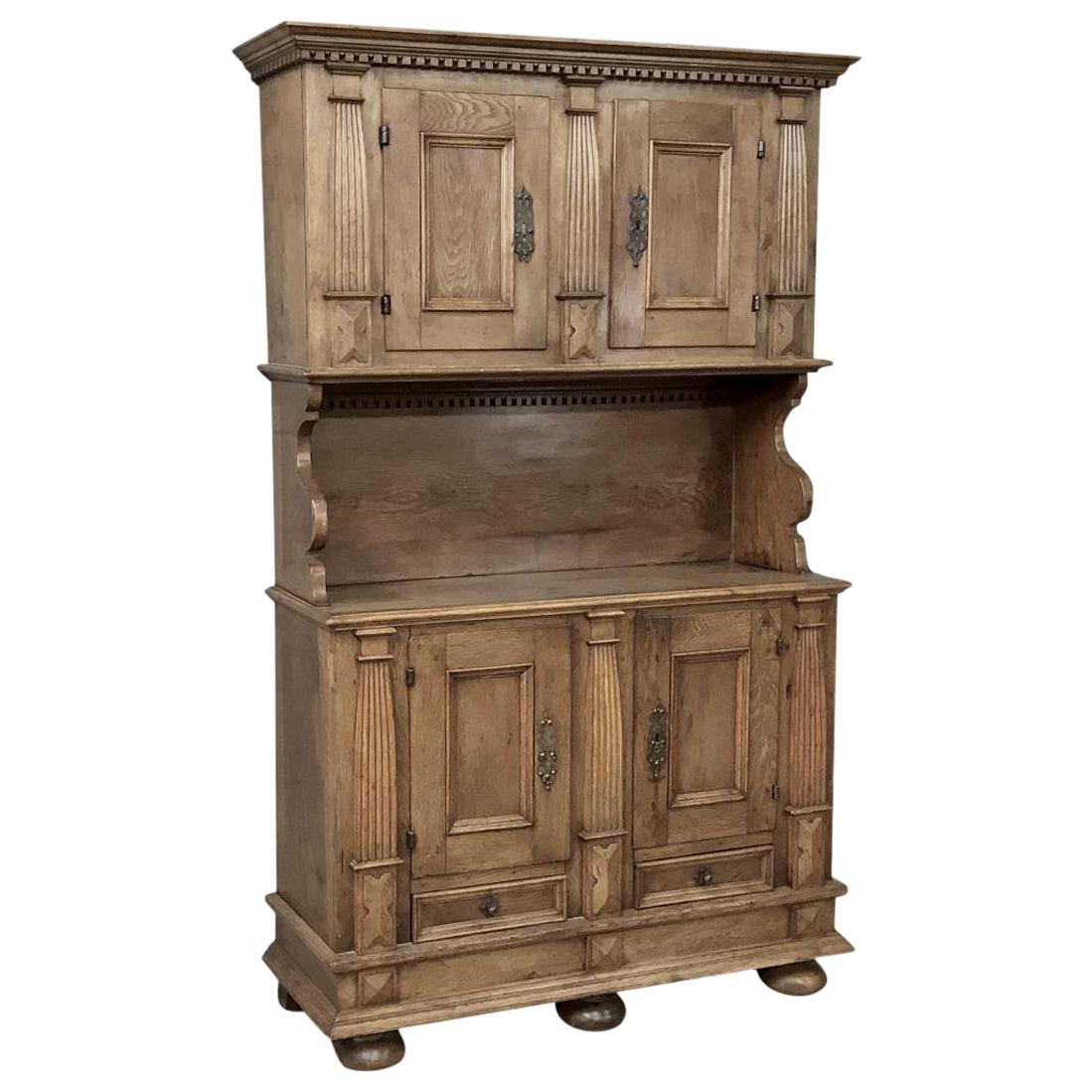 This handsome 18th century rustic Dutch oak two-tiered buffet was literally built to last for centuries out of dense, old-growth quarter sawn oak, and features some amazing hand-crafted detailing that is reminiscent of the later Arts & Crafts