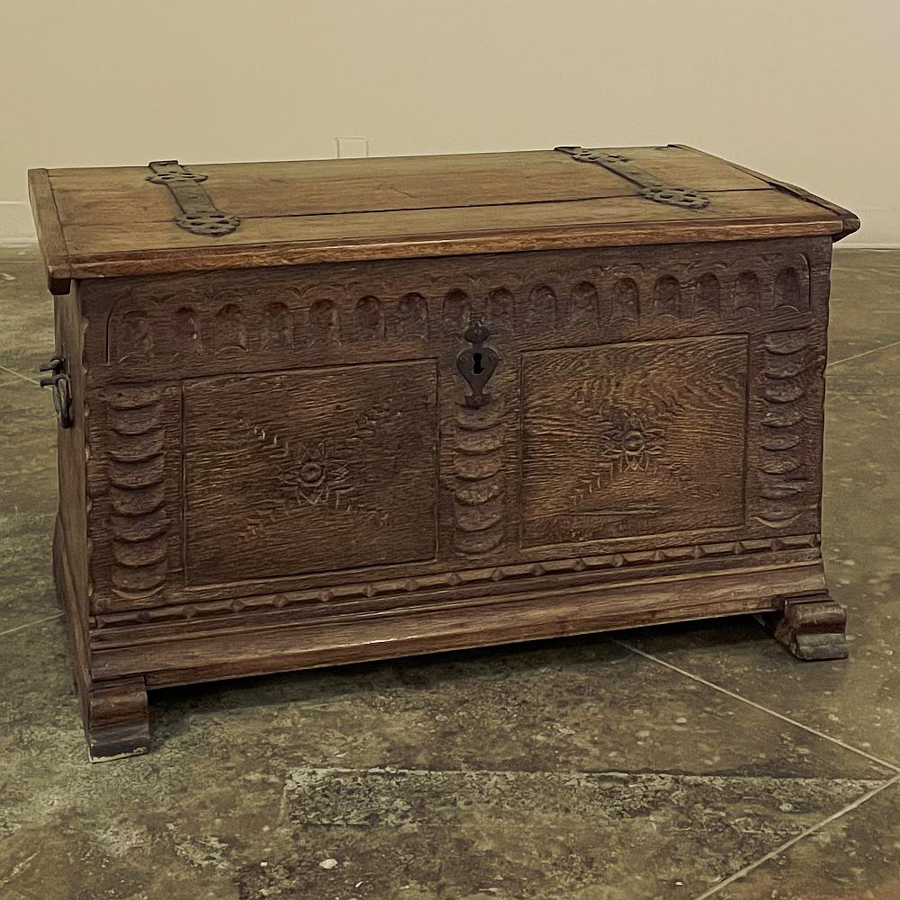 18th Century rustic dutch trunk was fashioned from old-growth oak using nothing but hand tools by capable rural artisans. The solid planks were joined together with traditional methods, then the top was formed with stabilizing rails on each side.