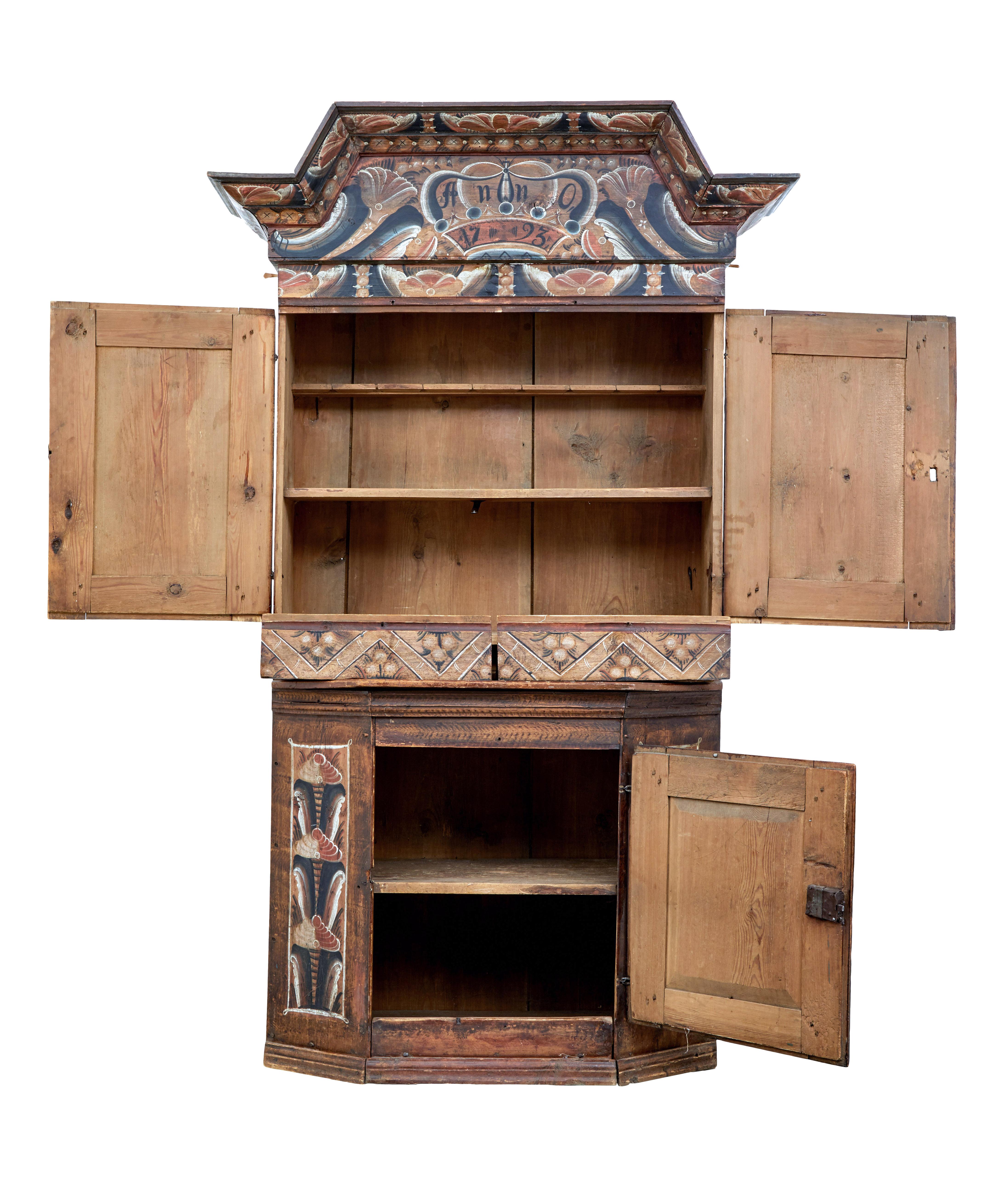 18th century rustic hand painted Swedish cupboard circa 1793.

Beautiful 3 part shaped Folk Art cupboard from the late 18th century. 3 parts consisting of removable cornice, top and bottom sections.

Hand painted and dated 1793. Double door
