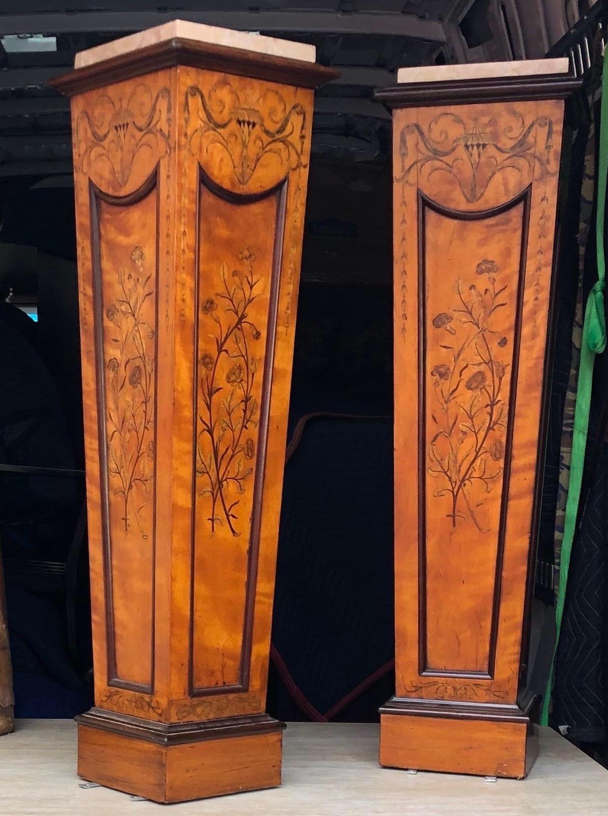 19th century satinwood pedestals with incredible inlay. Possibly Edwards and Roberts. Later marble tops.