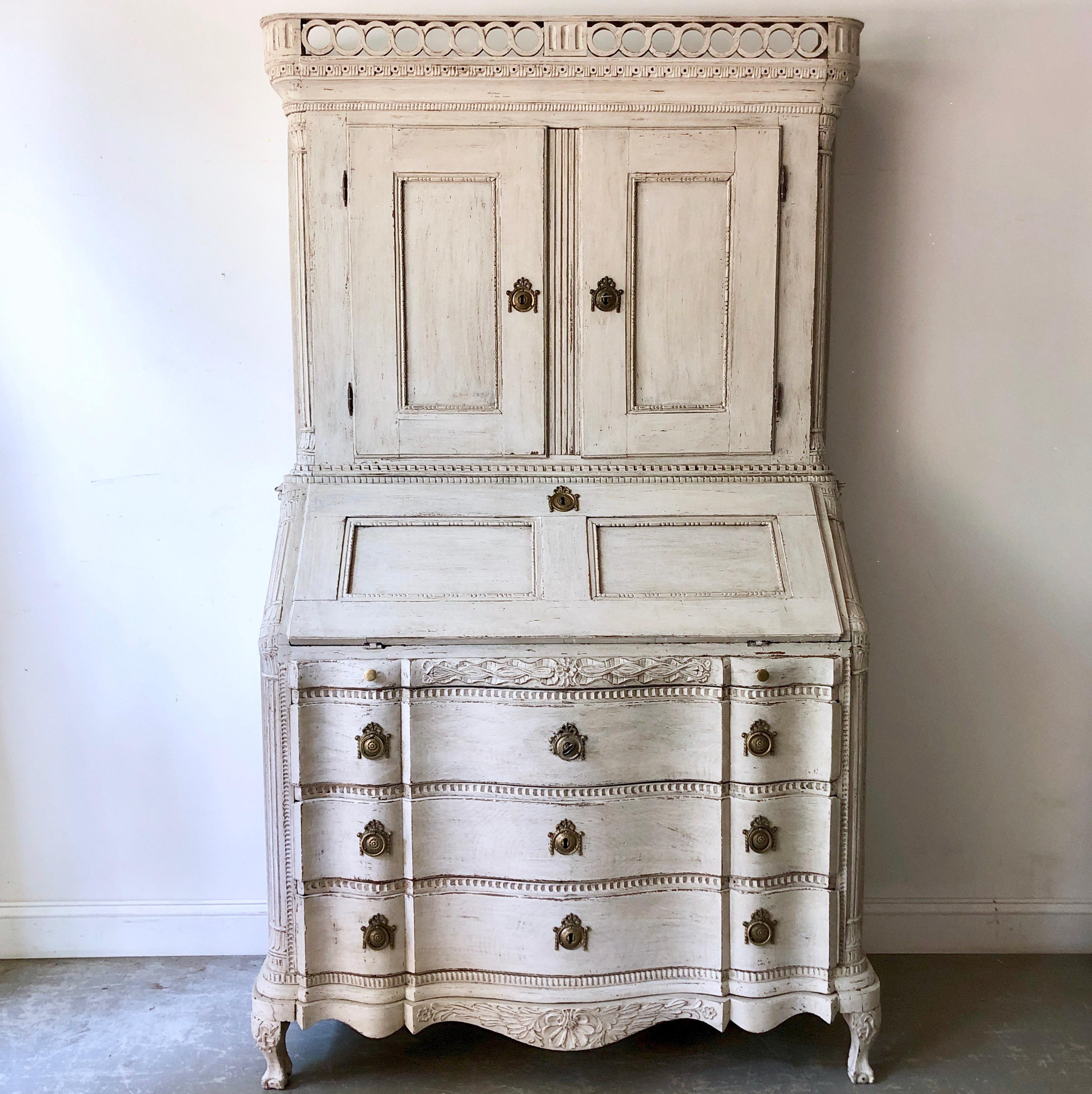 Very fine example of 18th century Scandinavian Baroque period secretaire with richly carved balcony pediment cornice and serpentine fronted drawers, carved fall front desk with several small drawers and compartments on carved cabriole feet,
circa