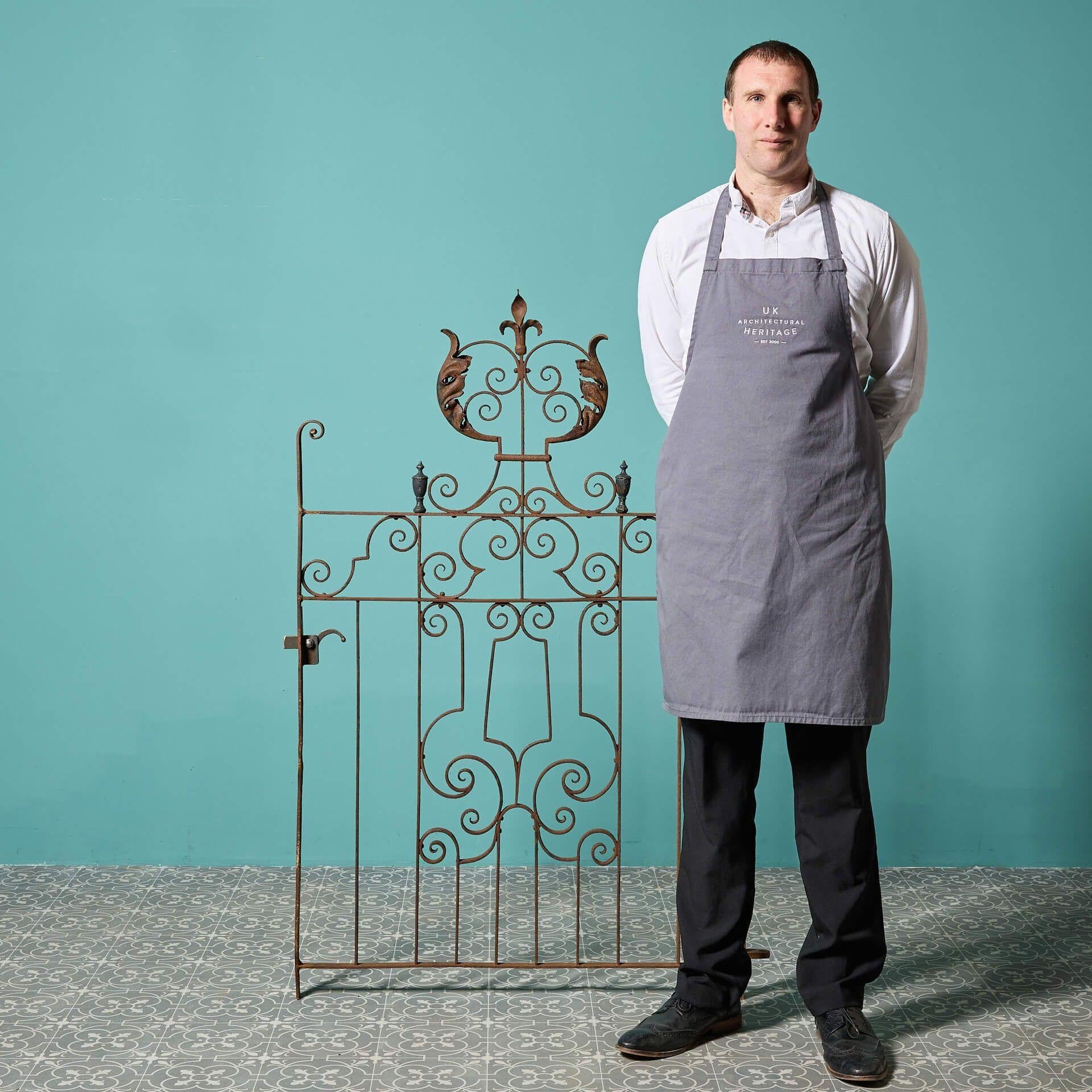 A beautiful and finely-made antique wrought iron side gate, reclaimed from an estate in rural Scotland.
 
Dating from circa 1780, this late 18th century gate is an original from the Georgian period and features ornate scrollwork alongside urn