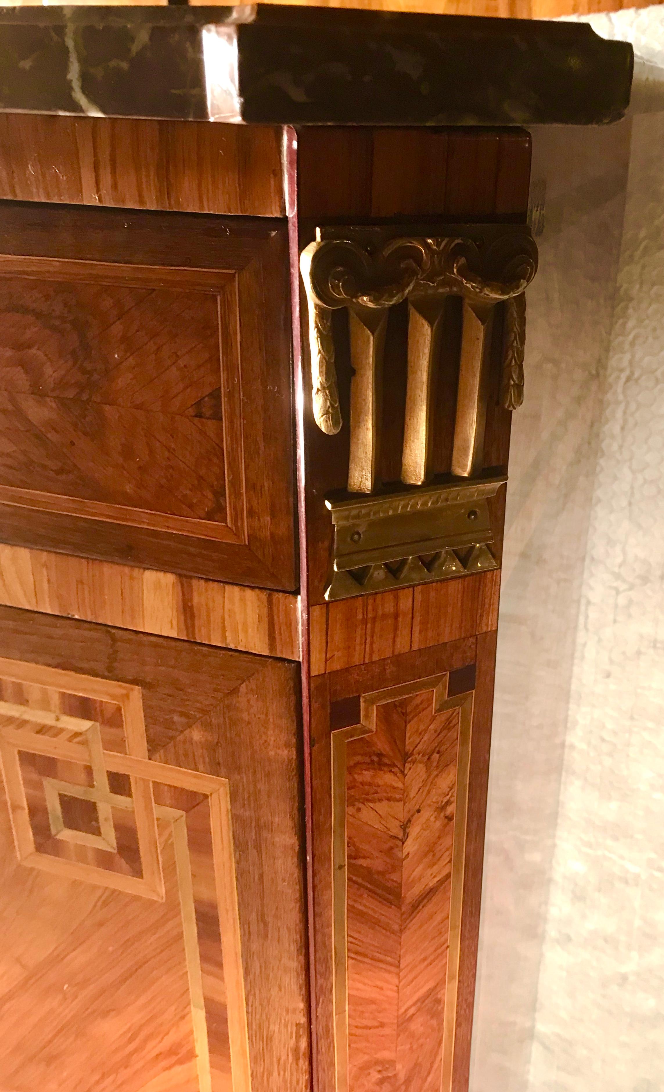 Exquisite secretaire a abattant (fall top desk), Paris 1780, kingwood and rosewood veneer on the outside. The inside additionally with mahogany veneer. With the original marble top and the original bronze fittings. Under the top on the right side