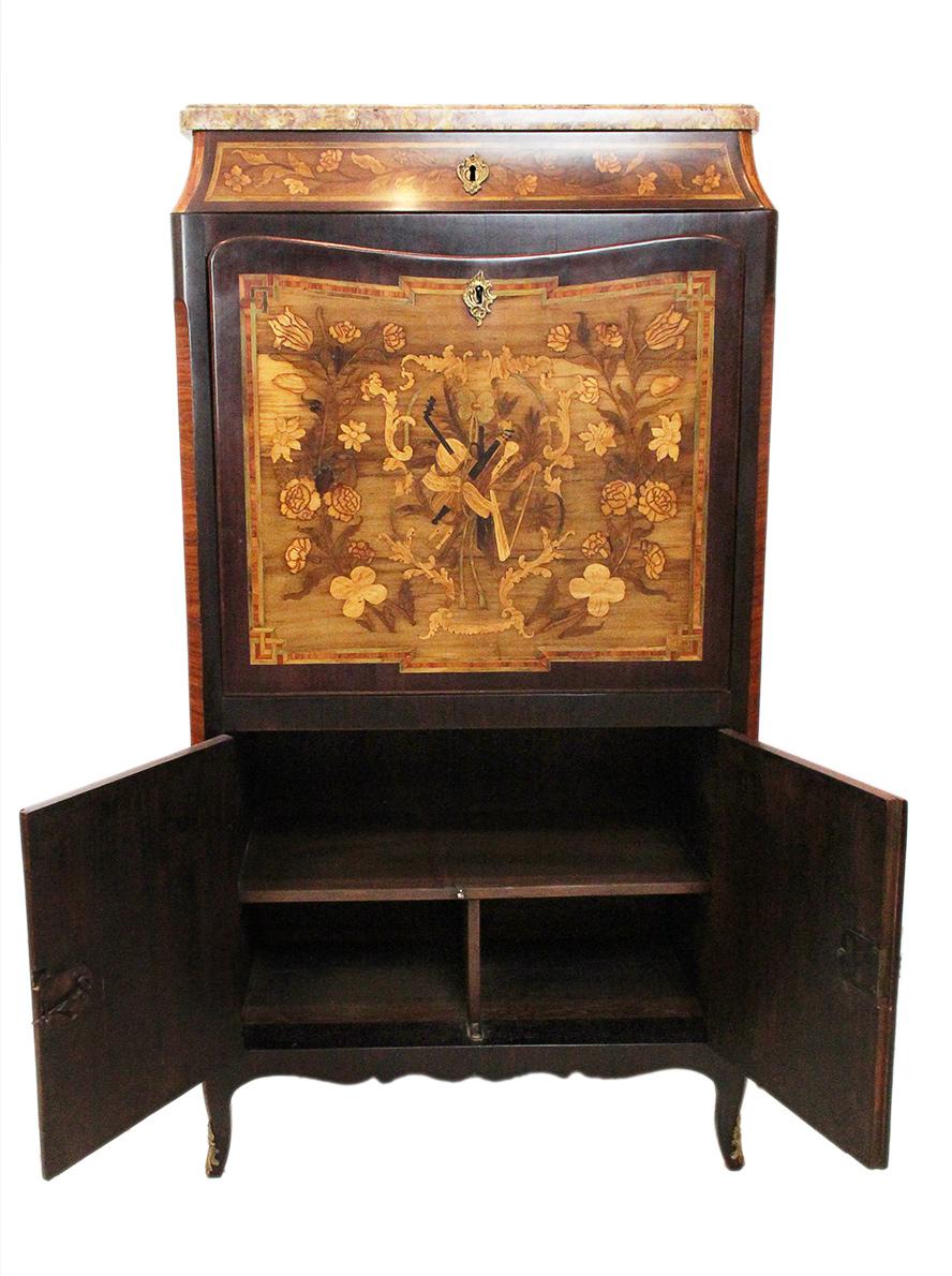 18th Century Secretaire with flower and musical theme marquetry and marble top :
Charming lady's secretaire with marble top, probably Parisian work. 
Superb marquetry work on the three sides with floral pattern. 
18th century furniture of the