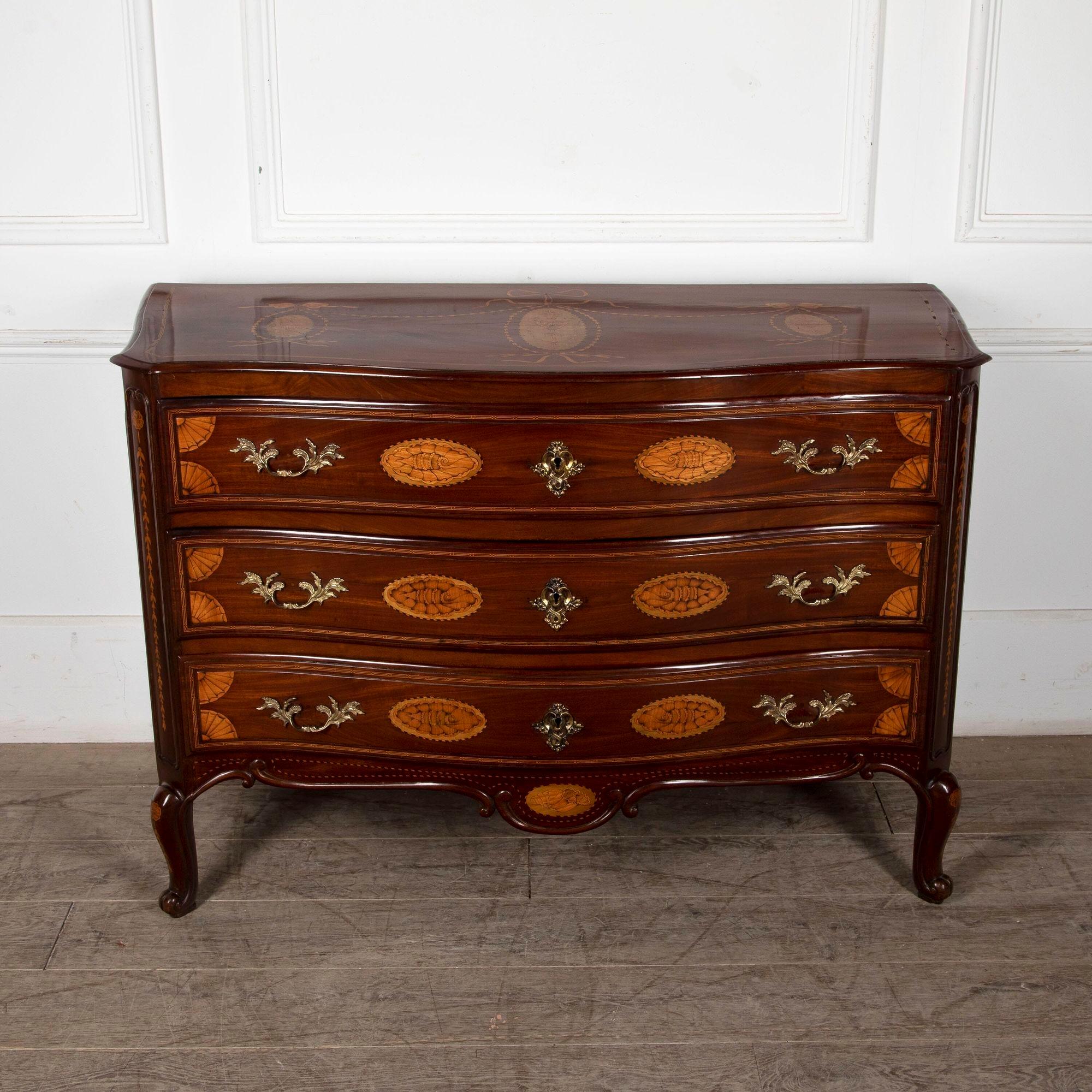 Fine quality 18th century Serpentine commode in mahogany and satinwood inlay. 
This commode stands well and is beautifully proportioned with its serpentine front and shell inlay. With swags to the top and drawer fronts.