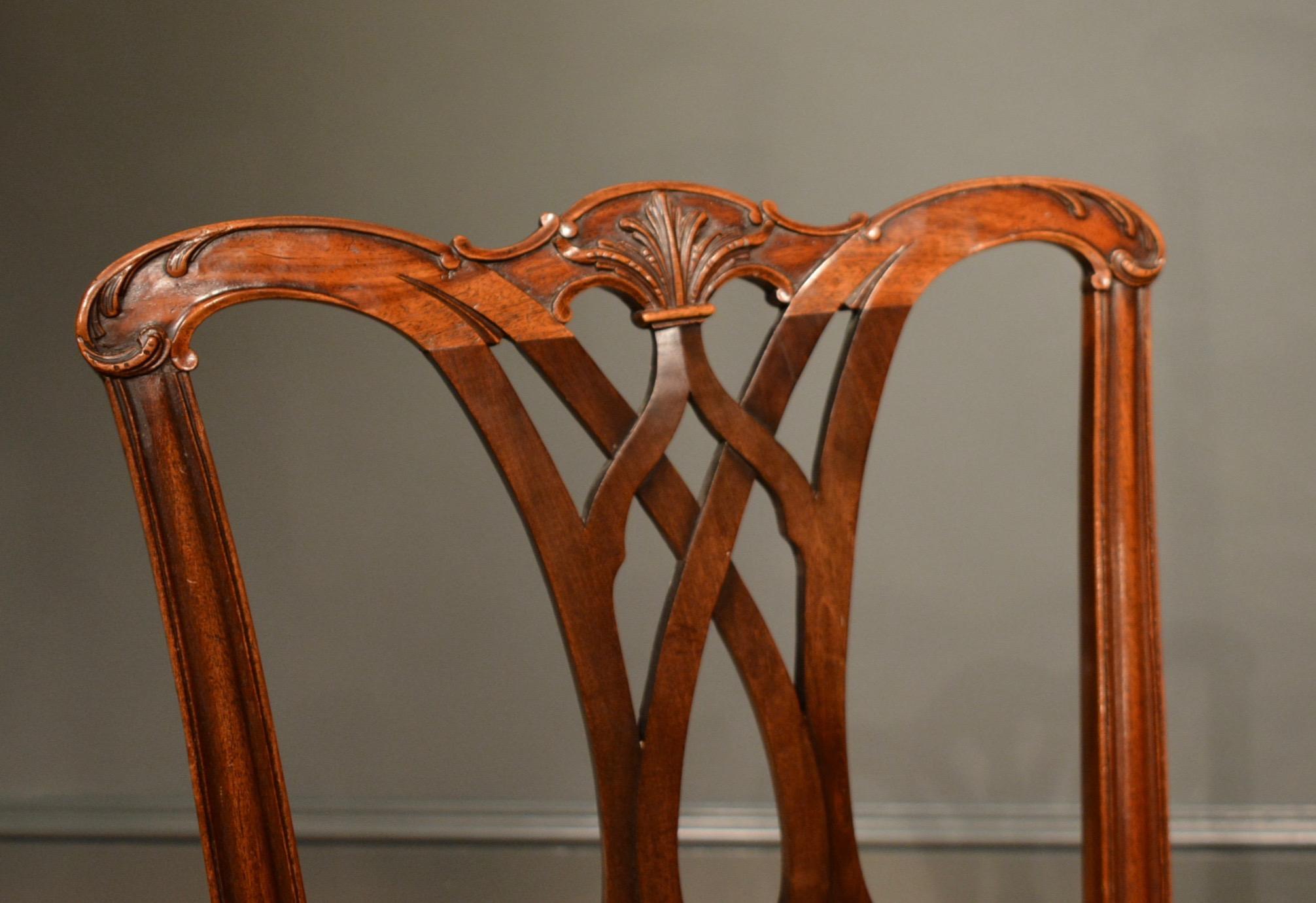 A set of 10 Chippendale mahogany dining chairs, the carved backs above stuff over seats with plain legs and stretchers.