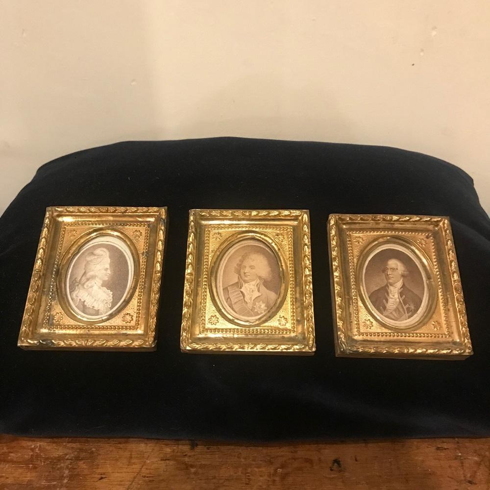 An exquisite set of three miniature 18th century Georgian pressed brass frames on wood backing, with old monochrome prints depicting:
The Princess of Wales(Caroline of Brunswick),
The Prince of Wales (George IV) and 
King George III. Small