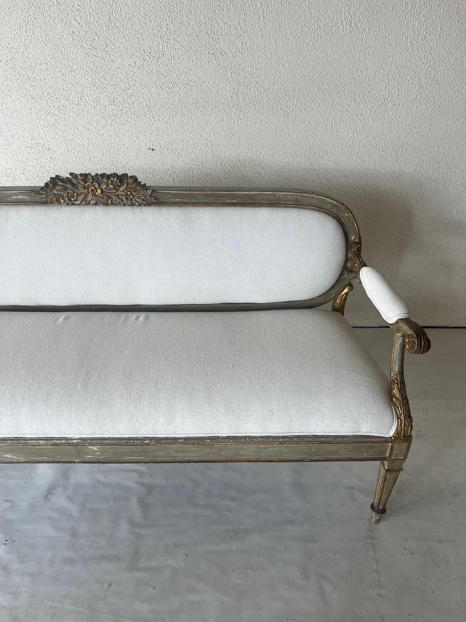 Stunning 18th Century Settee with gilded accents and new upholstery. Frame has a beautiful faux finish and great age.