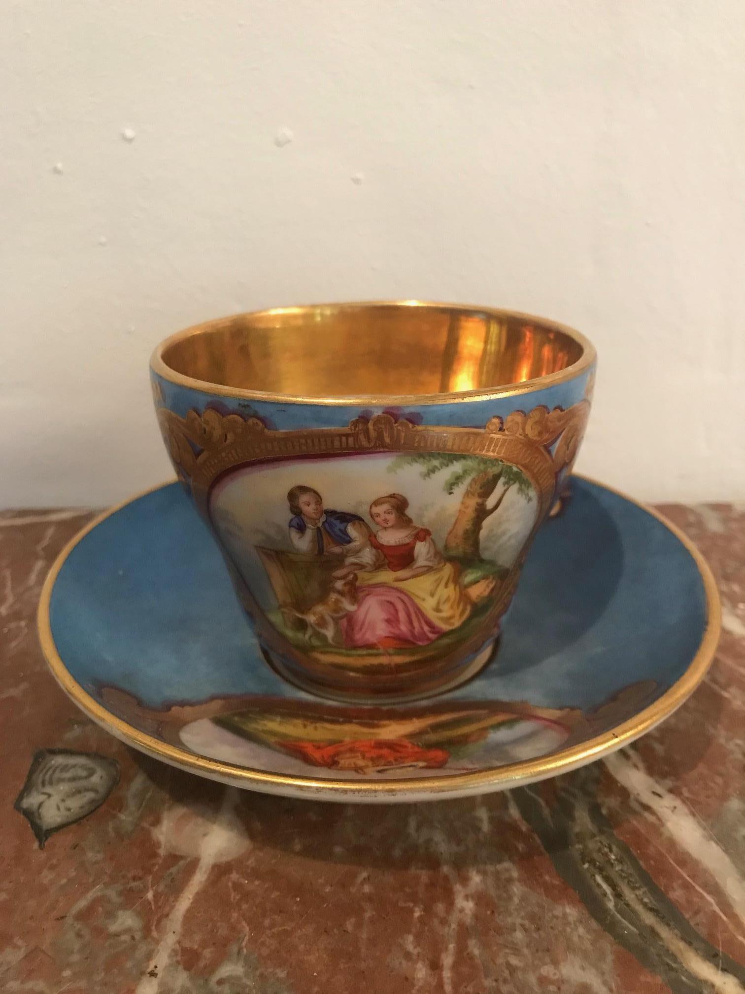 An 18th century Sèvres cup and saucer with the S Sèvres makers mark. The cup features two exquisitely painted Romantic figures and a gold leaf inner rim.