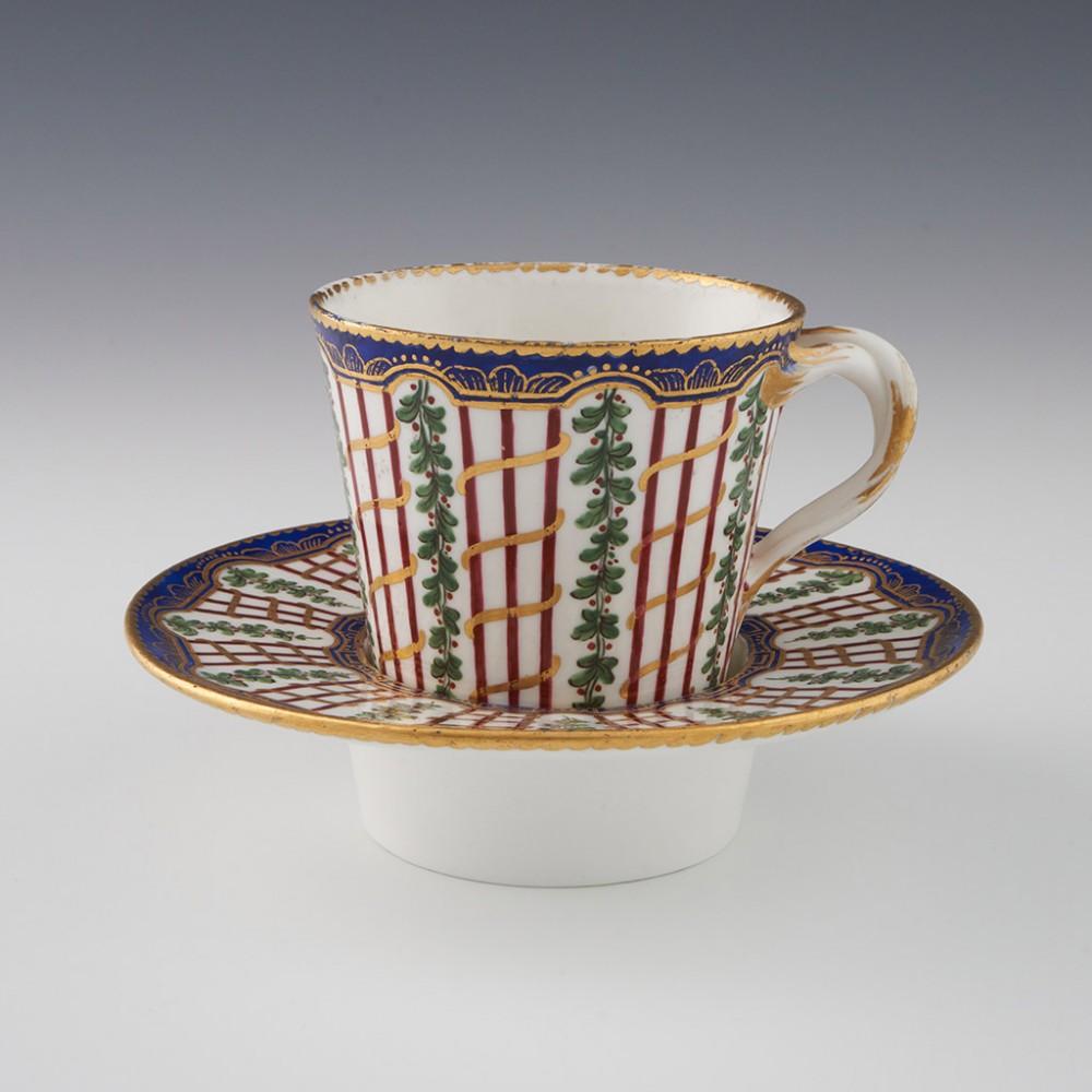 Heading :  18th Century Sevres 1st Size Trembleuse Cup and Saucer
Date : Late 18th Century c1790
Marks : Interlaced L mark in blue. Incised OO mark on base of the cup
Origin : Sevres, France
Colour : Polychrome
Pattern : Known as 'Hop Trellis' to