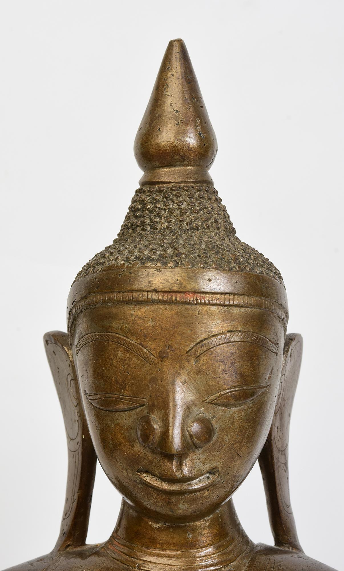 Antique Burmese bronze Buddha sitting in Mara Vijaya (calling the earth to witness) posture on a base.

Age: Burma, Shan Period, 18th Century
Size: Height 38.5 C.M. / Width 21.5 C.M. / Depth 9.5 C.M.
Condition: Nice condition overall (some expected