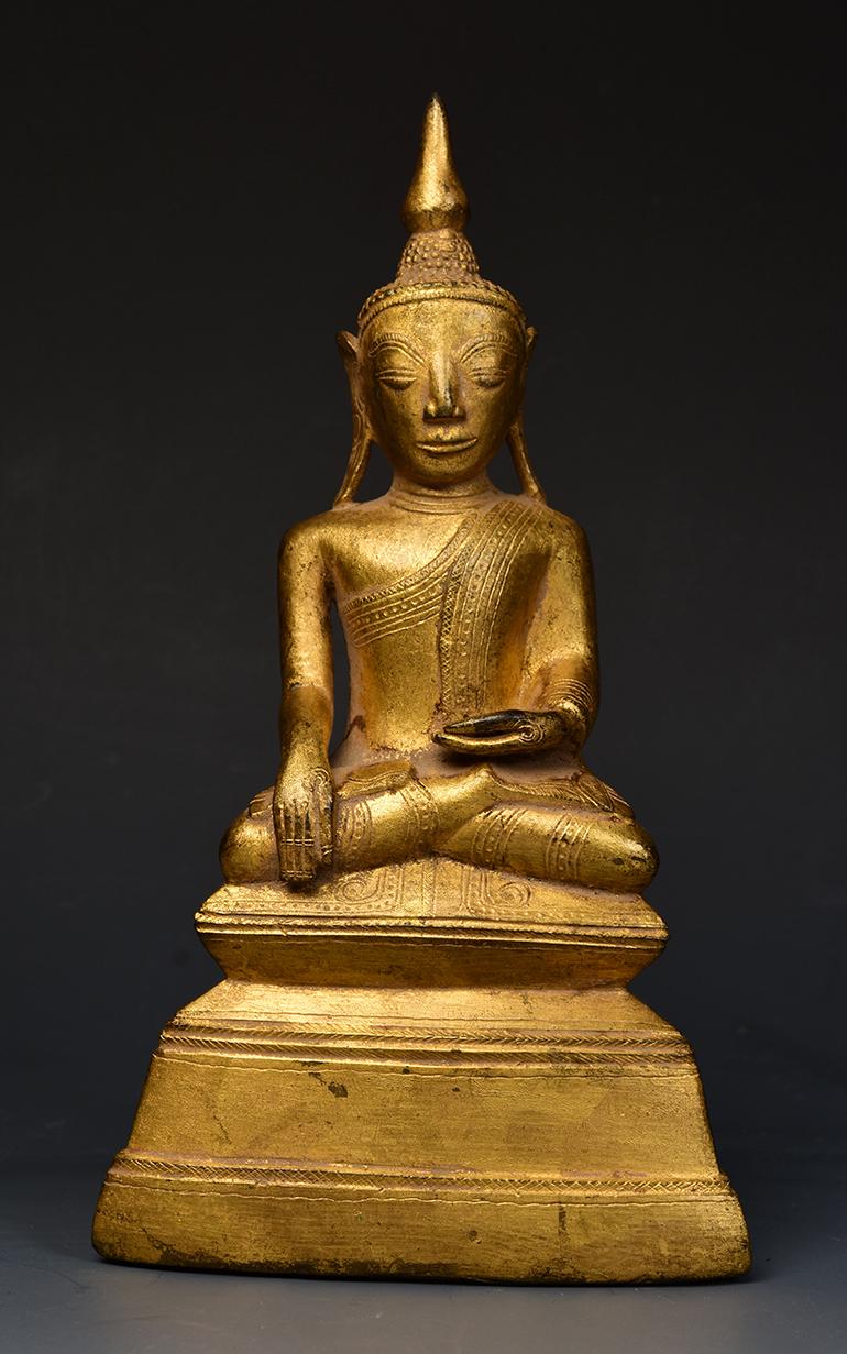 Burmese bronze Buddha sitting in Mara Vijaya (calling the earth to witness) posture on a base, with gilded gold.

Age: Burma, Shan Period, 18th Century
Size: Height 21 C.M. / Width 11.6 C.M.
Condition: Nice condition overall (some expected