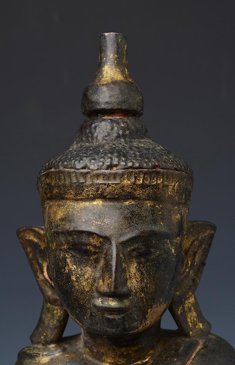 Burmese wooden Buddha sitting in Mara Vijaya (calling the earth to witness) posture on a base.

Age: Burma, Shan Period, 18th Century
Size: height 53.5 cm / width 20.5 cm.
Condition: Nice condition overall (some expected degradation due to its