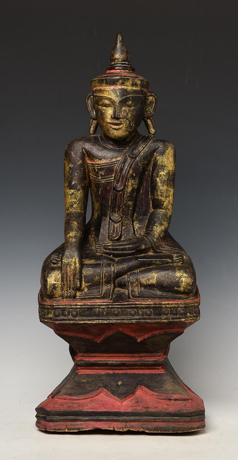 Burmese wooden Buddha sitting in Mara Vijaya (calling the earth to witness) posture on a base.

Age: Burma, Shan Period, 18th Century
Size: height 59 cm. / width 25.3 cm.
Condition: nice condition overall (some expected degradation due to its