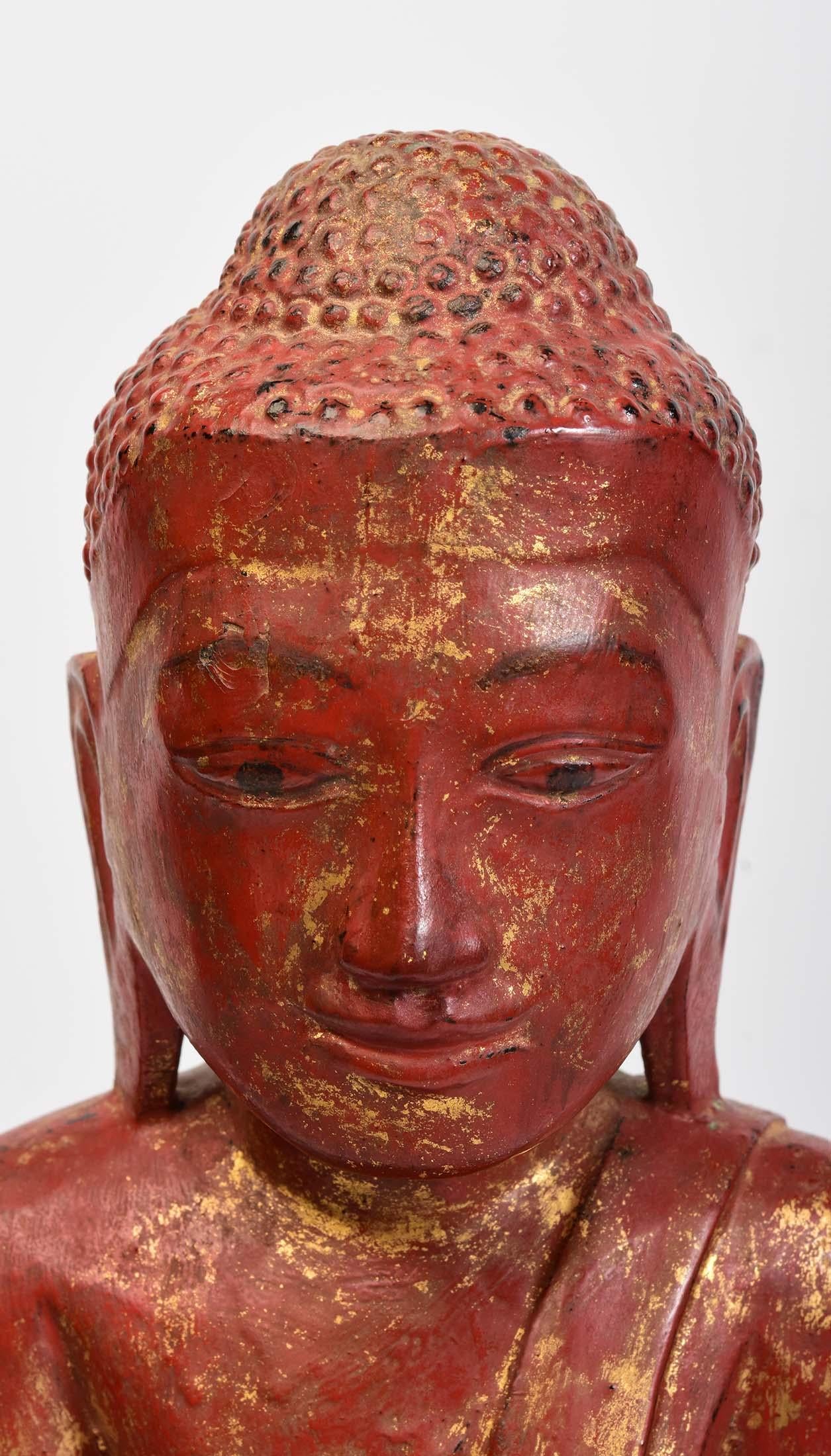 Burmese wooden Buddha sitting in Mara Vijaya (calling the earth to witness) posture on a base.

Age: Burma, Shan Period, 18th Century
Size: Height 45.4 C.M. / Width 15.8 C.M.
Size including stand: Height 47.3 C.M.
Condition: Nice condition overall