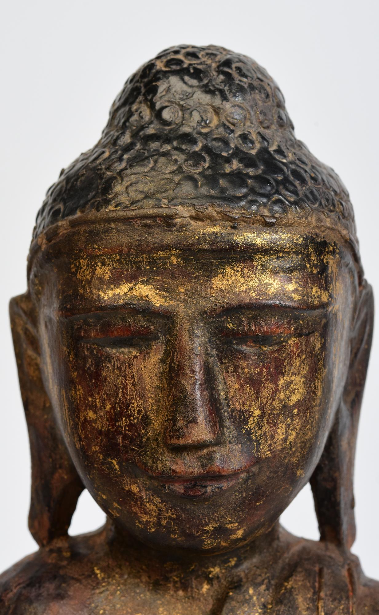 Antique Burmese wooden Buddha sitting in Mara Vijaya (calling the earth to witness) posture on a base.

Age: Burma, Shan Period, 18th Century
Size: Height 44 C.M. / Width 17 C.M. / Depth 8 C.M.
Condition: Nice condition overall (some expected