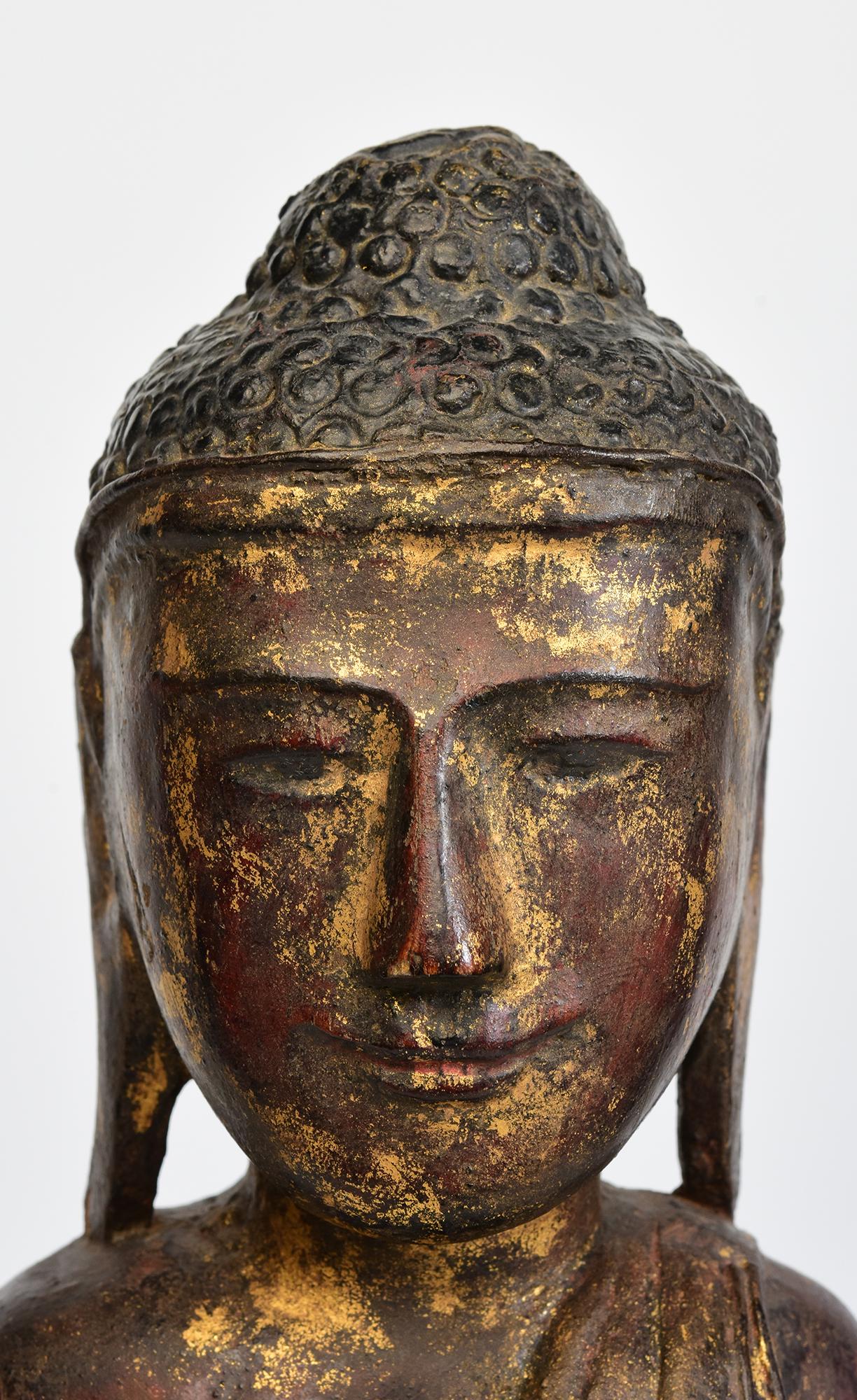 Antique Burmese wooden Buddha sitting in Mara Vijaya (calling the earth to witness) posture on a base.

Age: Burma, Shan Period, 18th Century
Size: Height 44.8 C.M. / Width 16.9 C.M. / Depth 10 C.M.
Condition: Nice condition overall (some expected