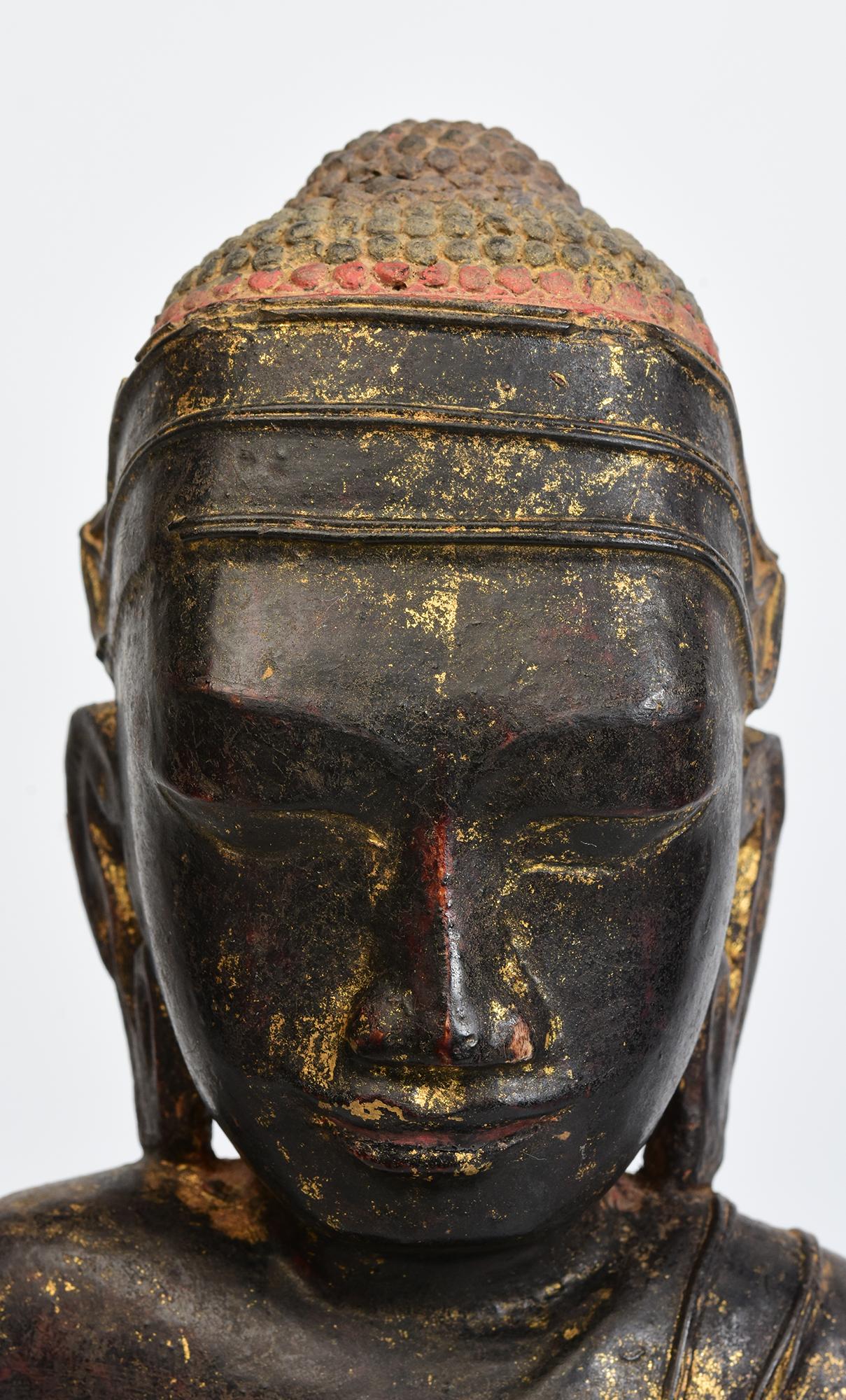 Burmese wooden Buddha sitting in Mara Vijaya (calling the earth to witness) posture on a base.

Age: Burma, Shan Period, 18th Century
Size: Height 44.5 C.M. / Width 17.2 C.M.
Condition: Nice condition overall (some expected degradation due to its