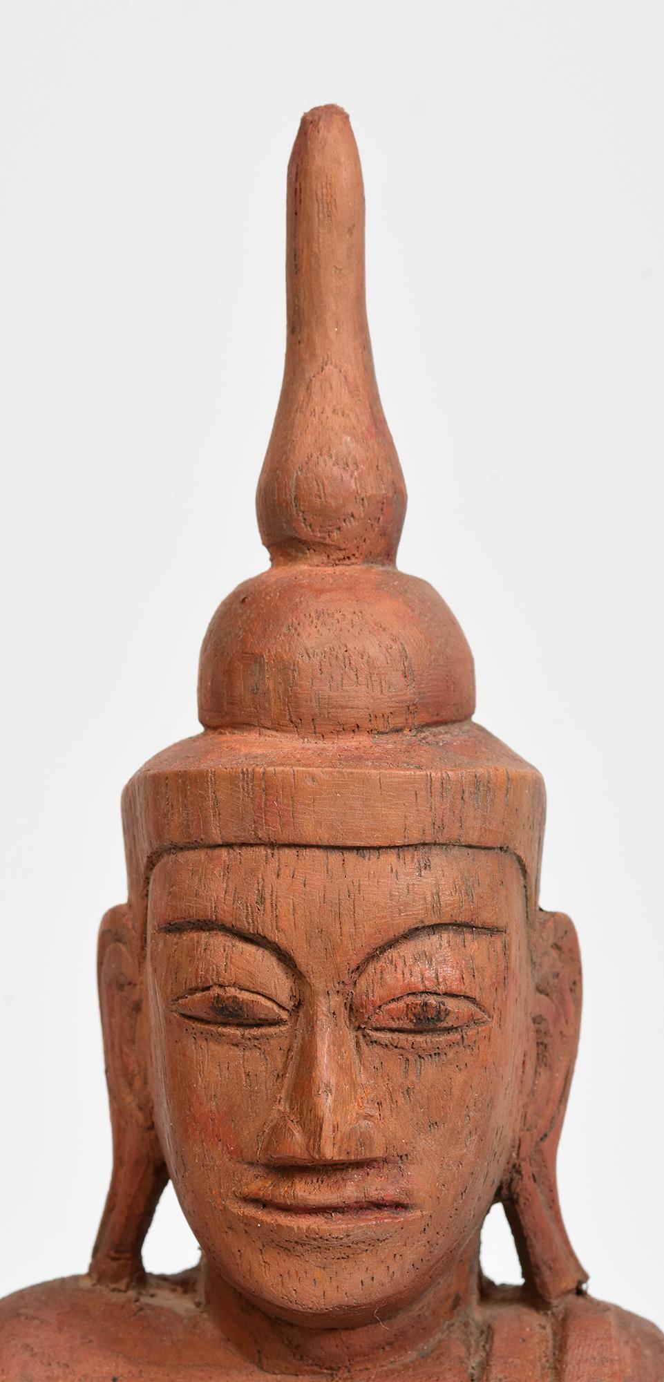 Burmese wooden Buddha sitting in Mara Vijaya (calling the earth to witness) posture on a base.

Age: Burma, Shan Period, 18th Century
Size: Height 30 C.M. / Width 12.3 C.M.
Condition: Nice condition overall (some expected degradation due to its