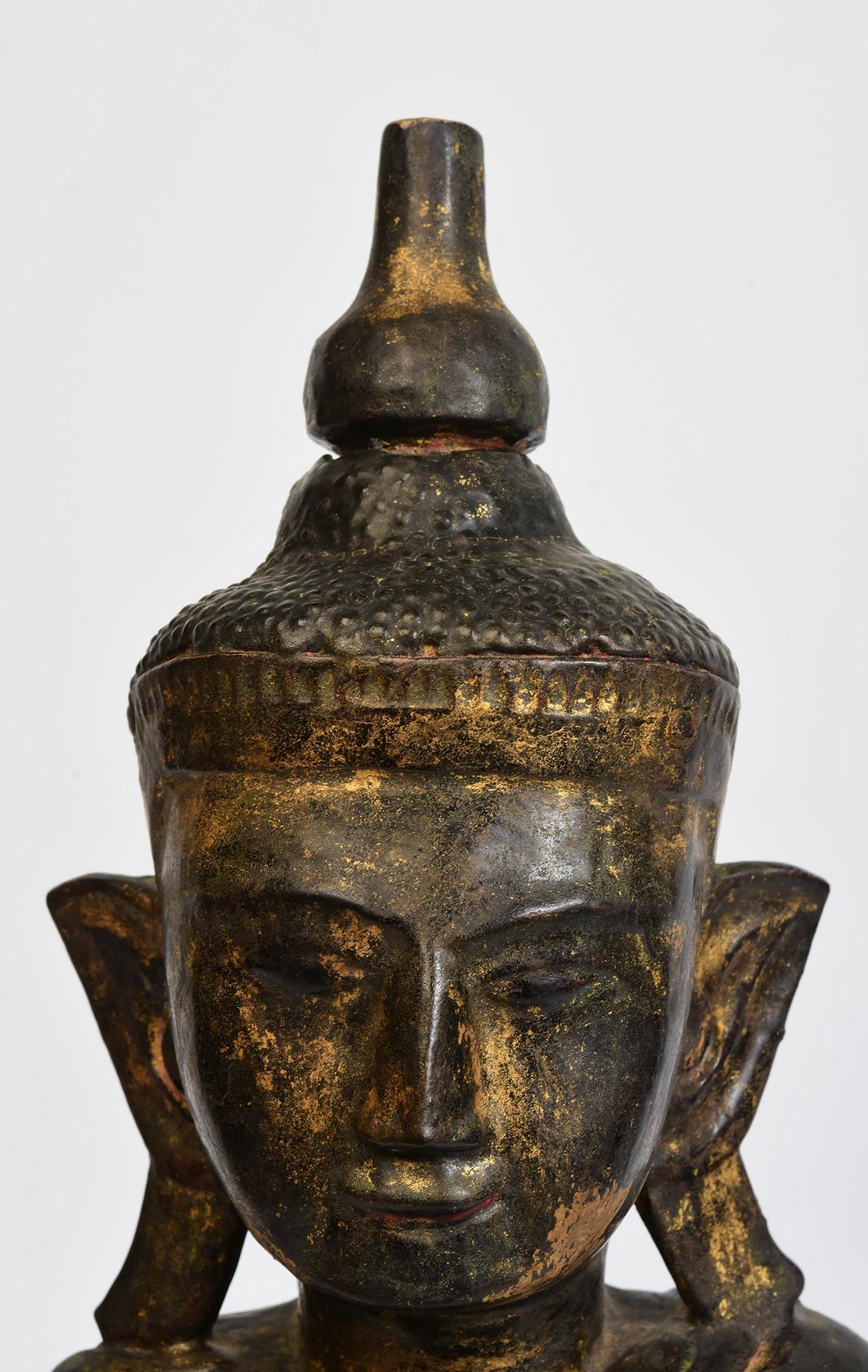 Burmese wooden Buddha sitting in Mara Vijaya (calling the earth to witness) posture on a base.

Age: Burma, Shan Period, 18th Century
Size: Height 53.5 C.M. / Width 20.5 C.M. / Depth 9.8 C.M.
Condition: Nice condition overall (some expected