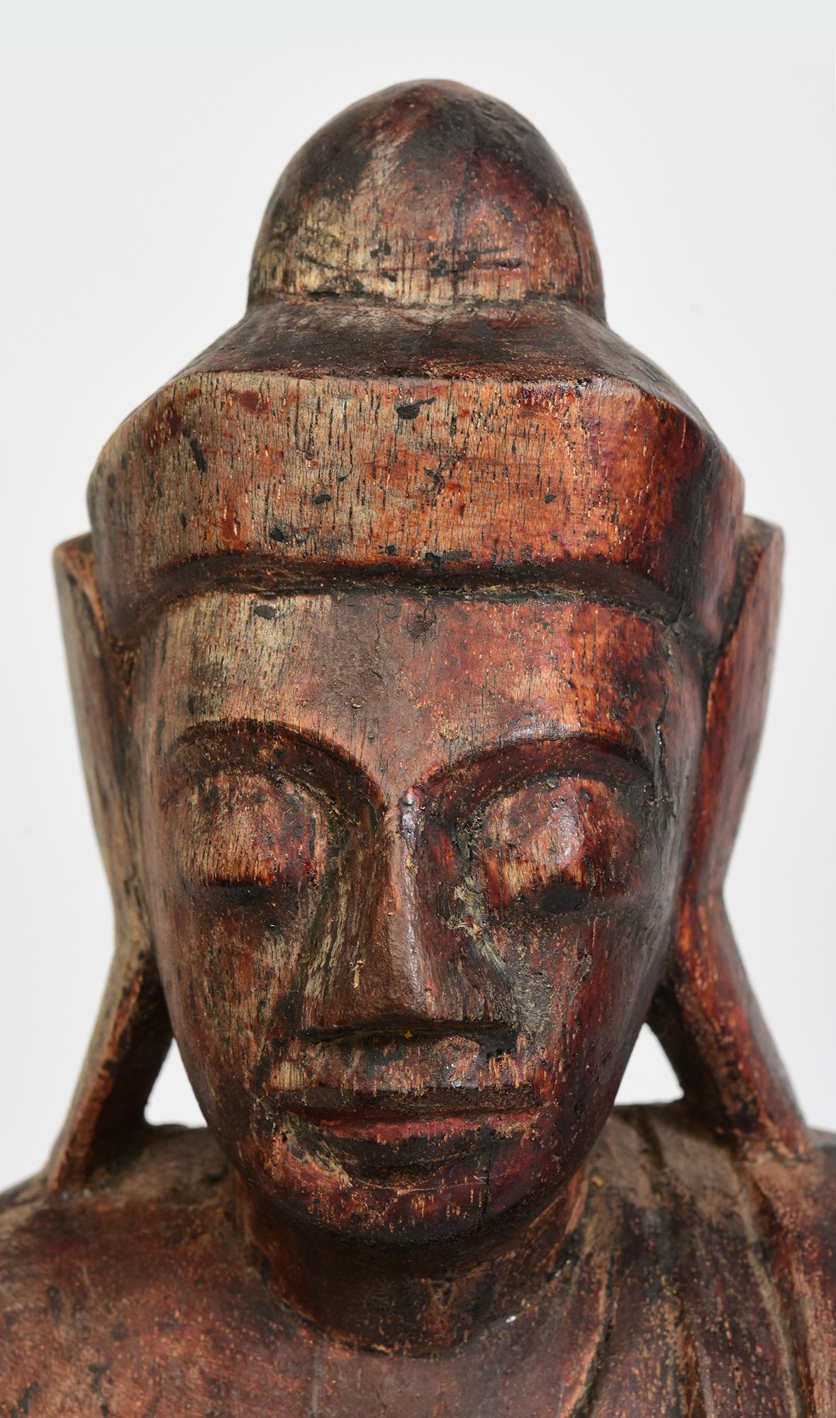 Burmese wooden Buddha sitting in Mara Vijaya (calling the earth to witness) posture on a base.

Age: Burma, Shan Period, 18th Century
Size: Height 40.4 C.M. / Width 20 C.M. / Depth 11 C.M.
Condition: Nice condition overall (some expected degradation