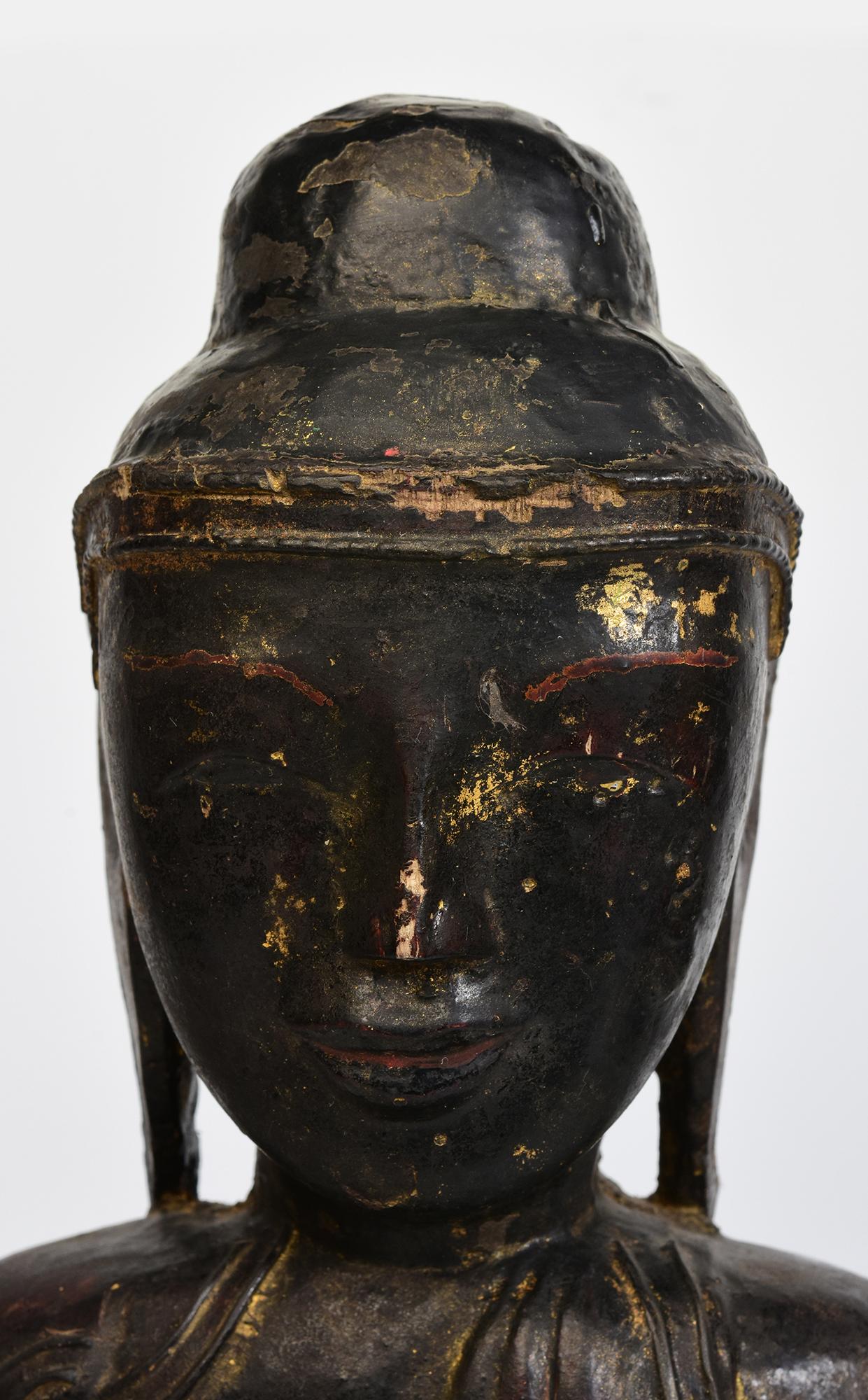 Burmese wooden Buddha sitting in Mara Vijaya (calling the earth to witness) posture on a base.

Age: Burma, Shan Period, 18th Century
Size: Height 50.6 C.M. / Width 31.2 C.M.
Condition: Nice condition overall (some expected degradation due to its