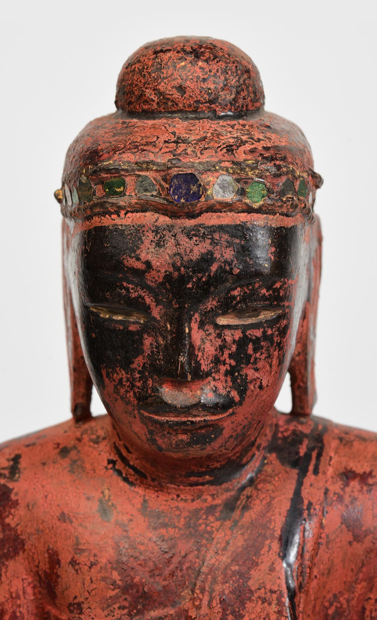Burmese wooden Buddha sitting in Mara Vijaya (calling the earth to witness) posture on a base.

Age: Burma, Shan Period, 18th Century
Size: Height 39.2 C.M. / Width 13.5 C.M. / Depth 7 C.M.
Height including stand: 41 C.M.
Condition: Nice condition