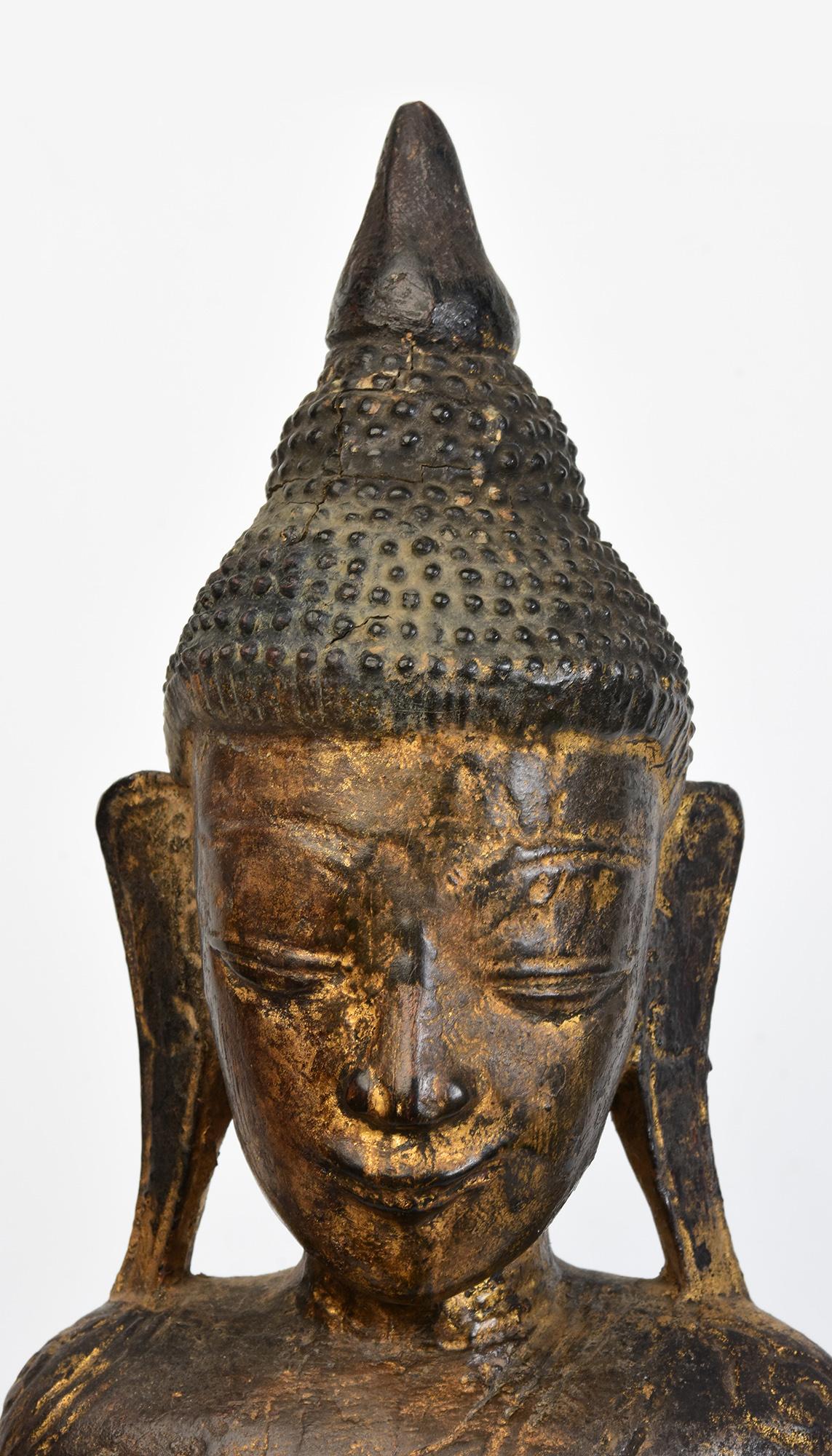 Antique Burmese wooden Buddha sitting in Mara Vijaya (calling the earth to witness) posture on a base.

Age: Burma, Shan Period, 18th Century
Size: Height 67.2 C.M. / Width 20.3 C.M. / Depth 14 C.M.
Condition: Nice condition overall (some expected