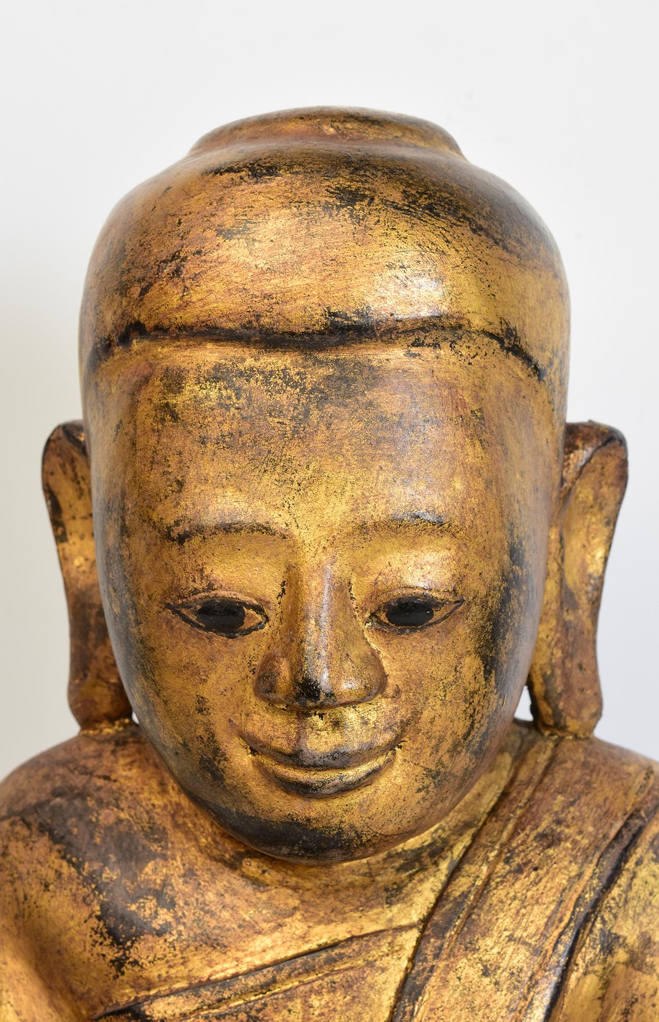 Antique Burmese wooden Buddha sitting in Mara Vijaya (calling the earth to witness) posture on a base with gilded gold.

Age: Burma, Shan Period, 17th Century
Size: Height 49.8 C.M. / Width 24.3 C.M. / Depth 14 C.M.
Condition: Nice condition overall