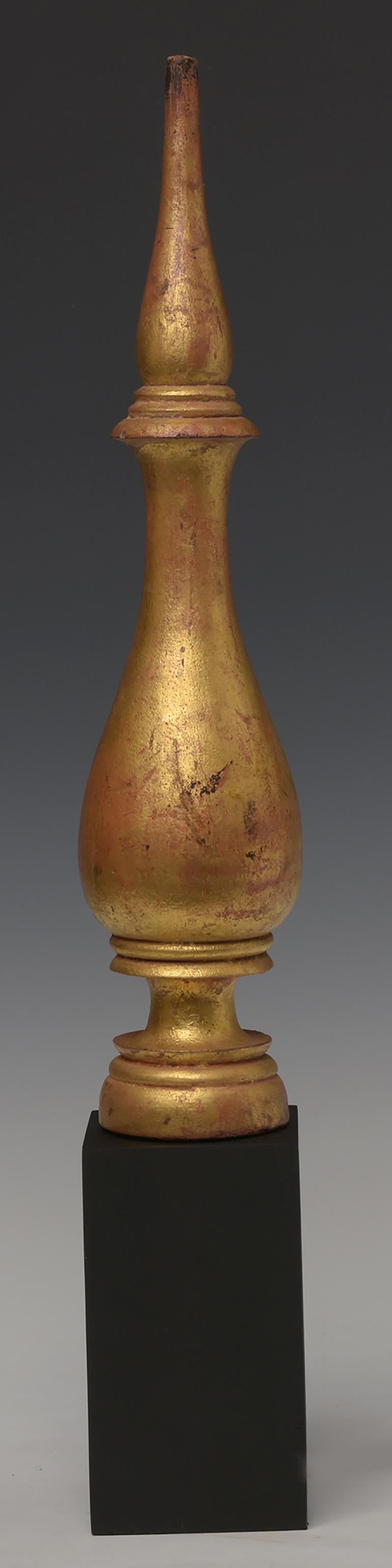 Antique Burmese wooden top of Buddha head, with gilded gold.

Age: Burma, Shan Period, 18th Century
Size of the top only: Height 40.4 C.M. / Width 8.5 C.M.
Height including stand: 55 C.M.
Condition: Nice condition overall (some expected degradation