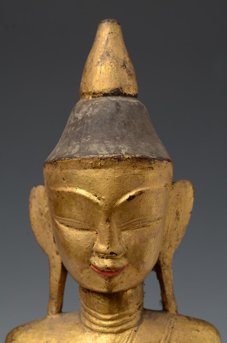Tai Lue Burmese wooden Buddha sitting in Mara Vijaya (calling the earth to witness) posture on a base, with gilded gold.

Tai Lue is a group of tribal people living in Burma. It is difficult to find Buddha from this ethnic group.

Age: Burma,
