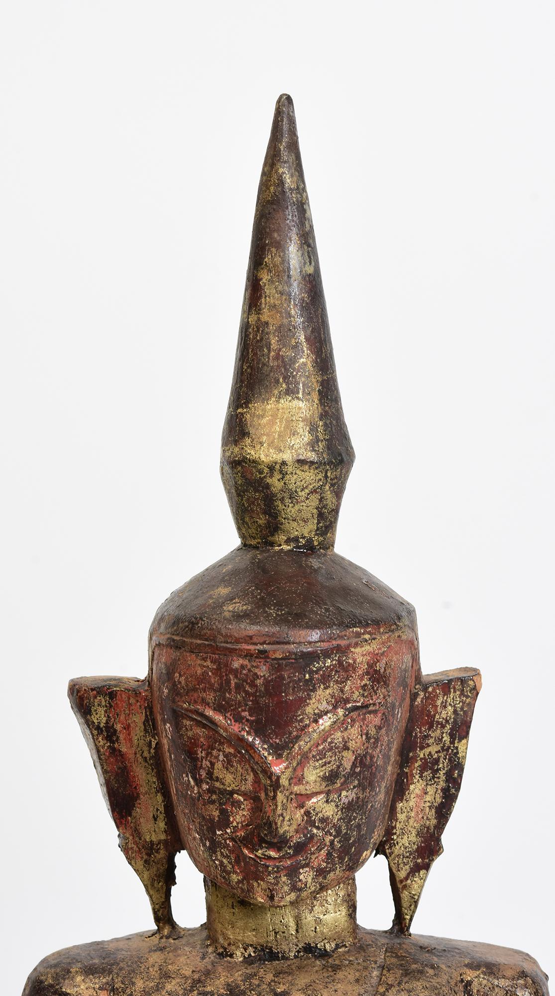 Tai Lue Burmese wooden Buddha sitting in Mara Vijaya (calling the earth to witness) posture on a base.

Tai Lue is a tribal people living in Burma, it is difficult to find Buddha from this ethnic group.
Tai Lue Buddhas look more primitive than