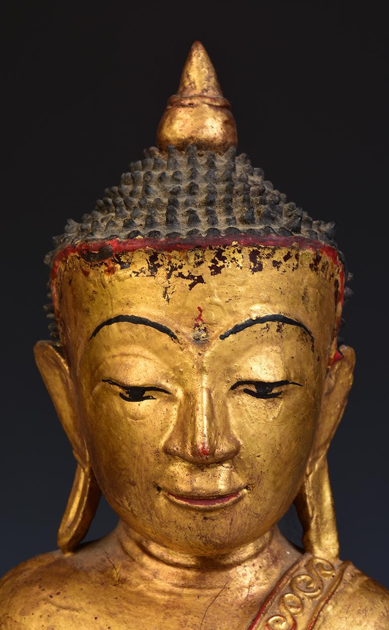 Tai Yai Burmese wooden Buddha sitting in Mara Vijaya (calling the earth to witness) posture on a base, with gilded gold.

Tai Yai is a group of tribal people living in Burma. It is difficult to find Buddha from this ethnic group.

Age: Burma, Shan
