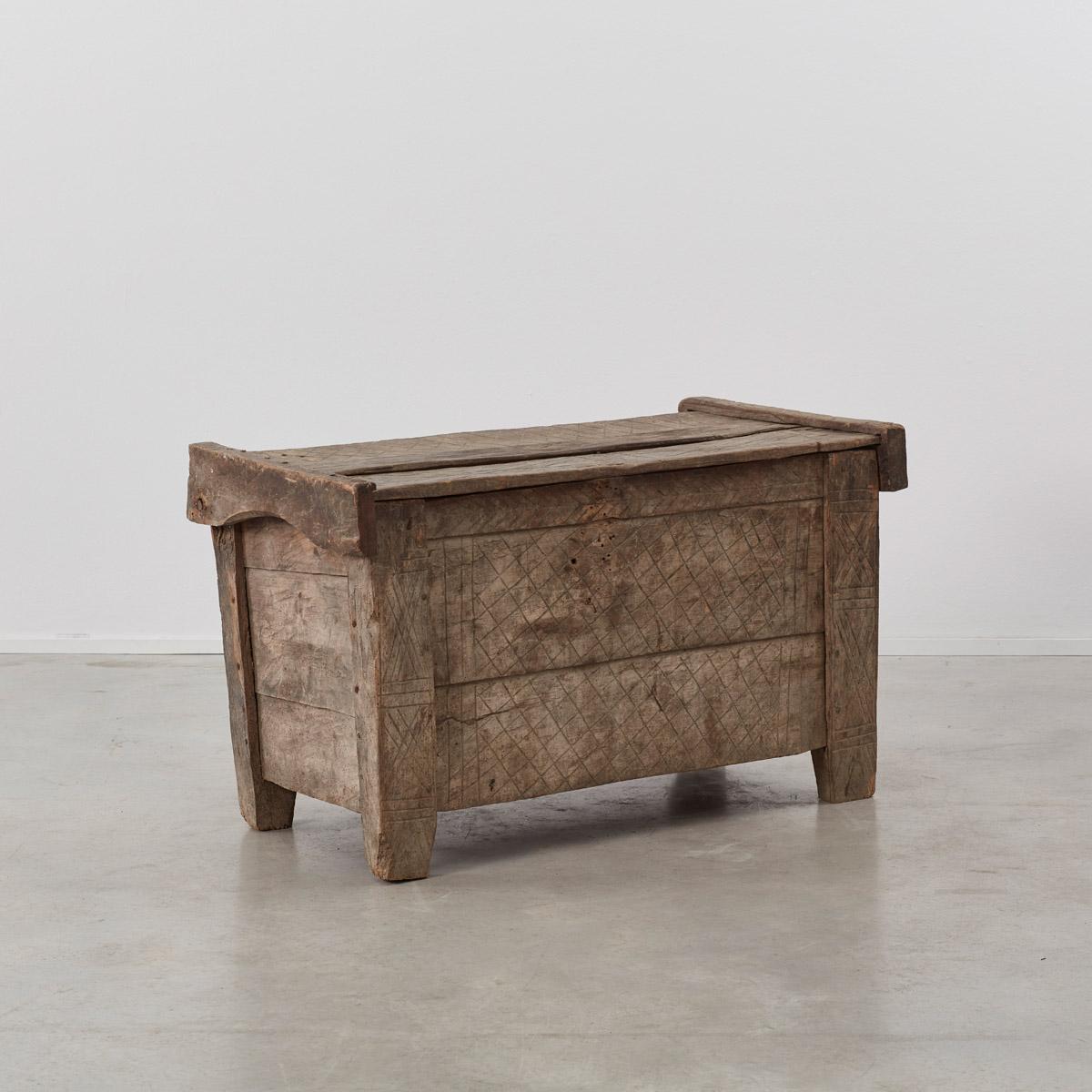 This is an excellent example of a naive hand carved shepherd’s coffer or trunk made in Transylvania in the 1700s. Constructed from hewn timbers naturally bleached to the color of stone. The mesh pattern carved across its surfaces is meant to deter