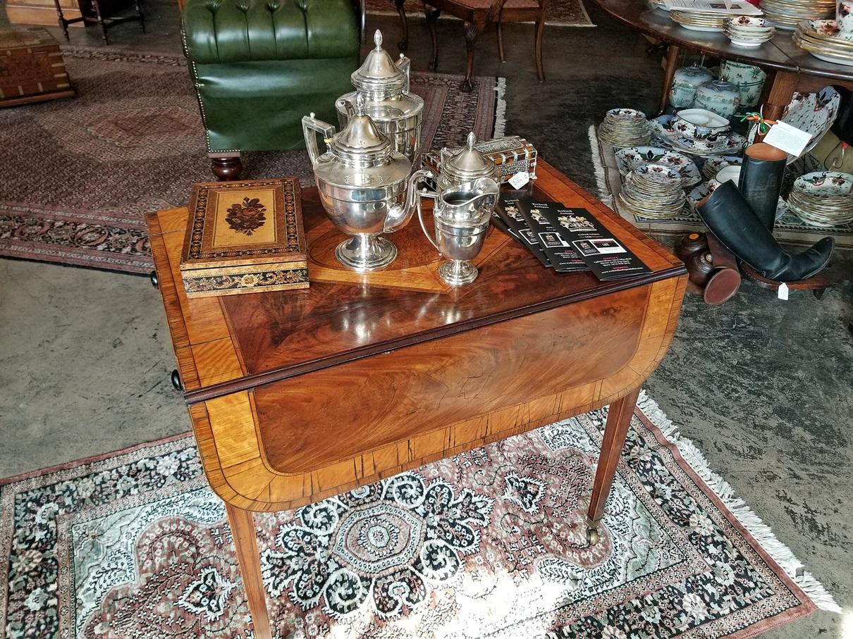 Glorious and very rare mahogany and satinwood Sheraton pembroke table with stunning patina. Classic Sheraton design, top and folding leaves made of the best flame Cuban mahogany, inlaid and banded with satinwood and stringing. The top has a central